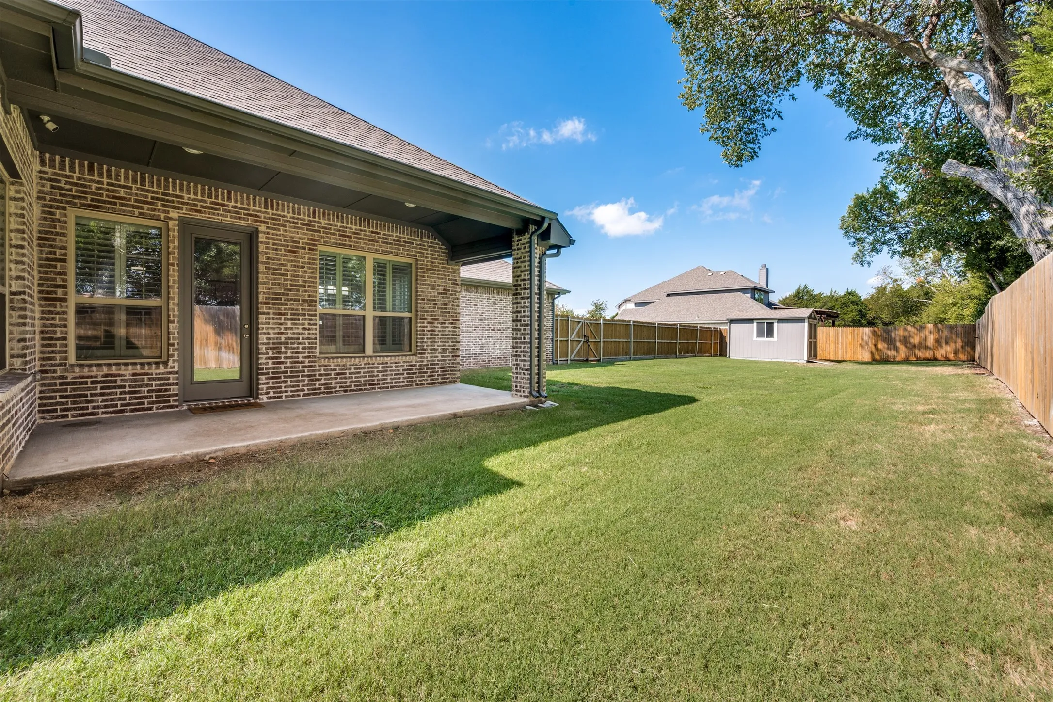 Enjoy your large backyard from the covered patio.  The house sits on approximately 1/3 of an acre.