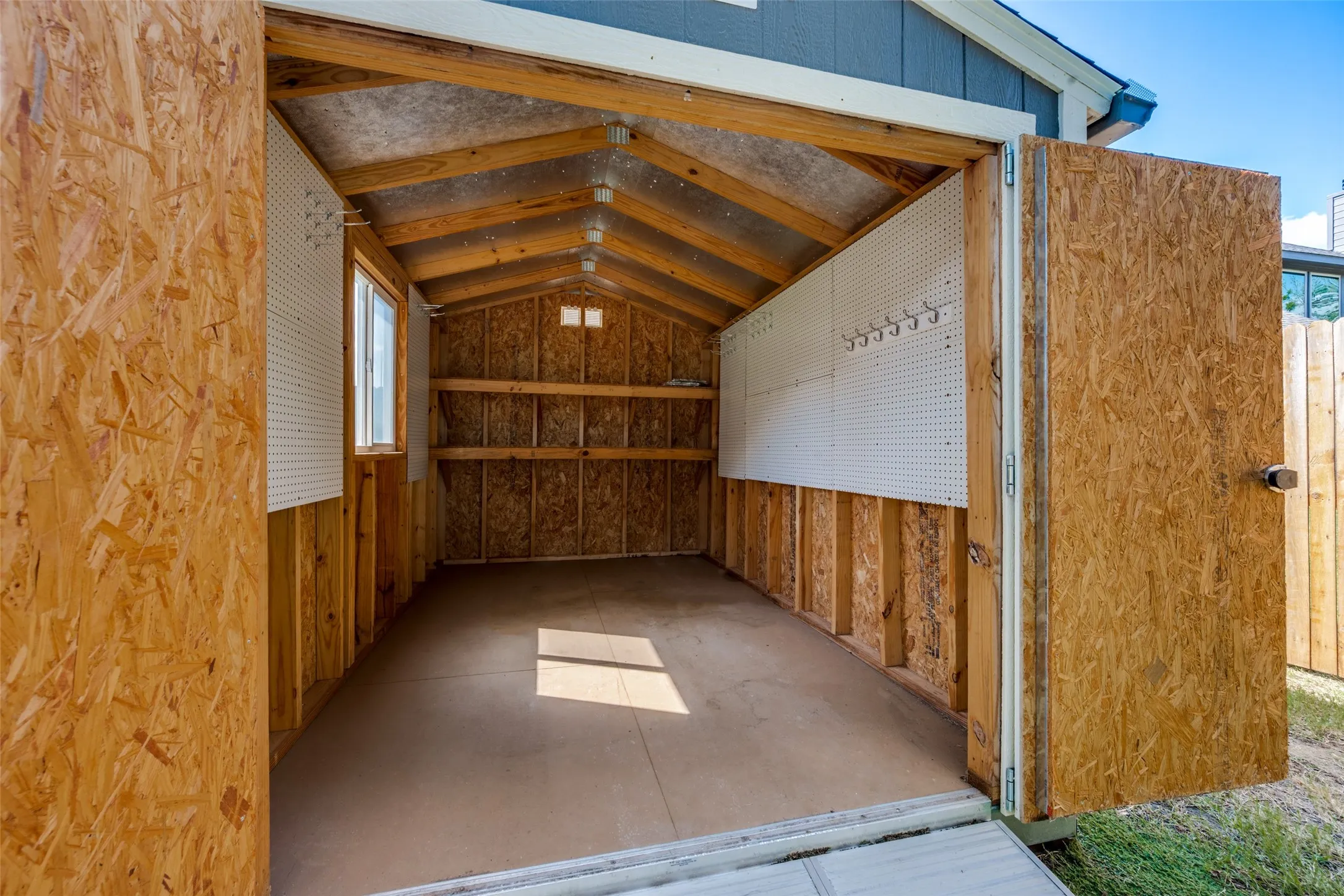 Cedar panels and peg boards add to the functionality of the storage shed.