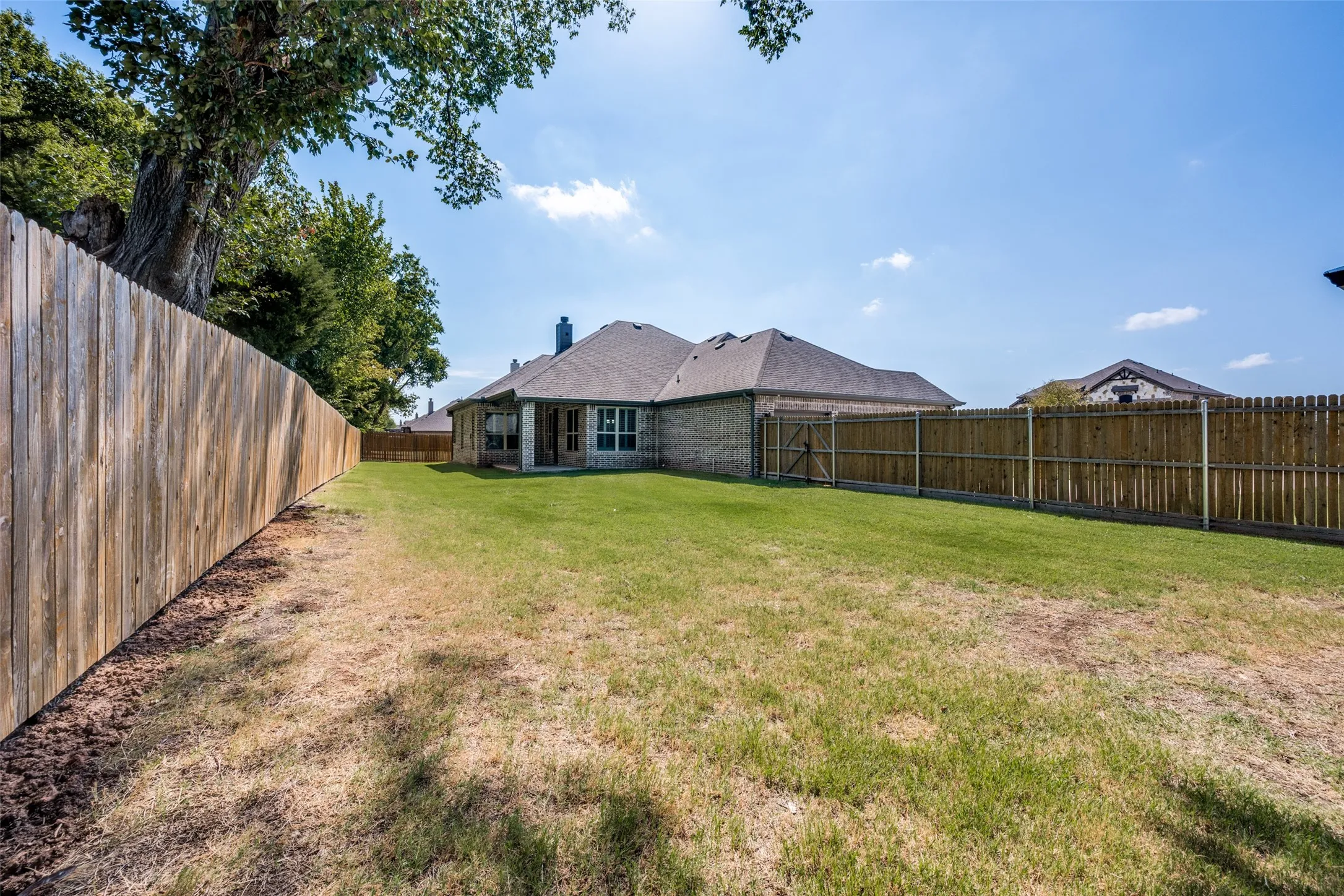 A look at the house from the far Northwest Corner of the yard. There is plenty of room to enjoy outdoor activities.
