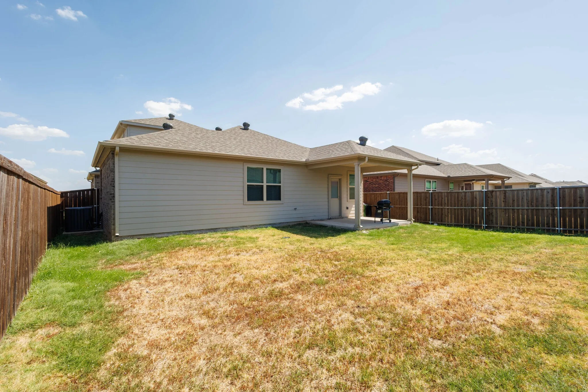 Full fenced yard with covered patio