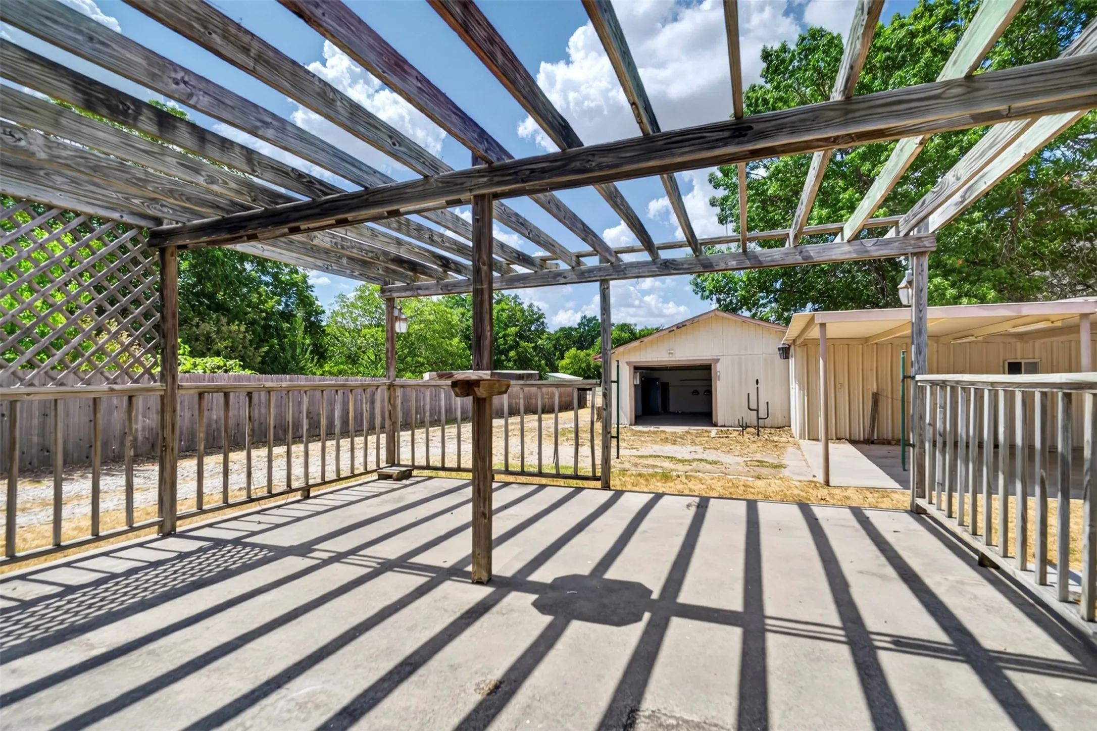 Concrete patio with a wooden pergola
