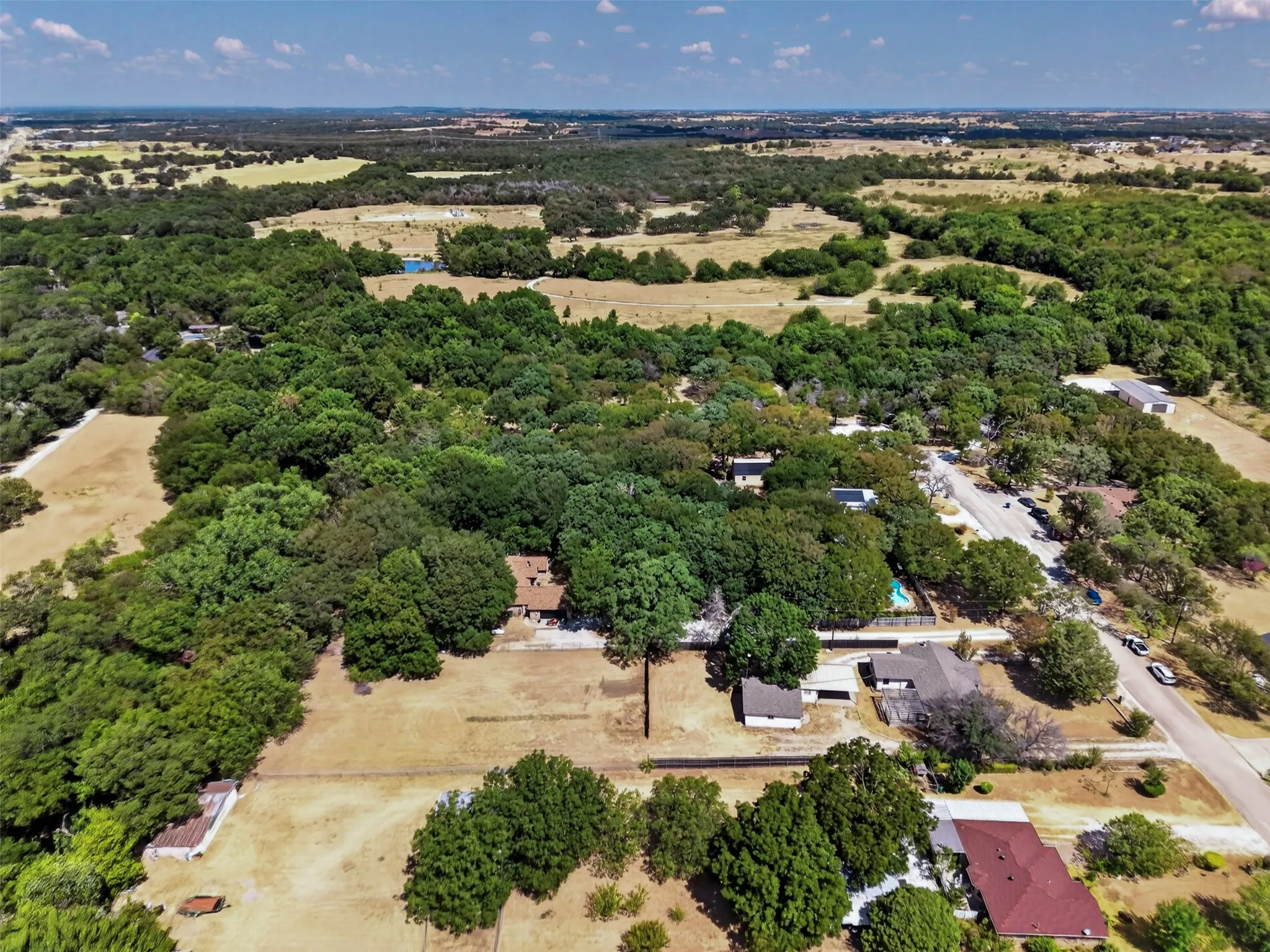 Expansive property featuring mature trees and open fields