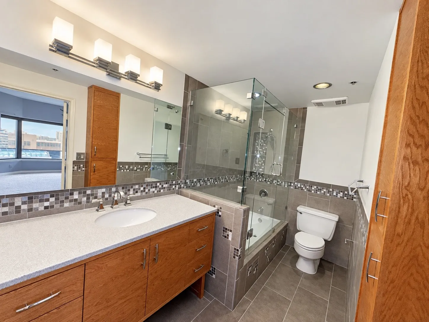 Vanity with a single basin, stone-finish countertop, and wood-finish cabinetry