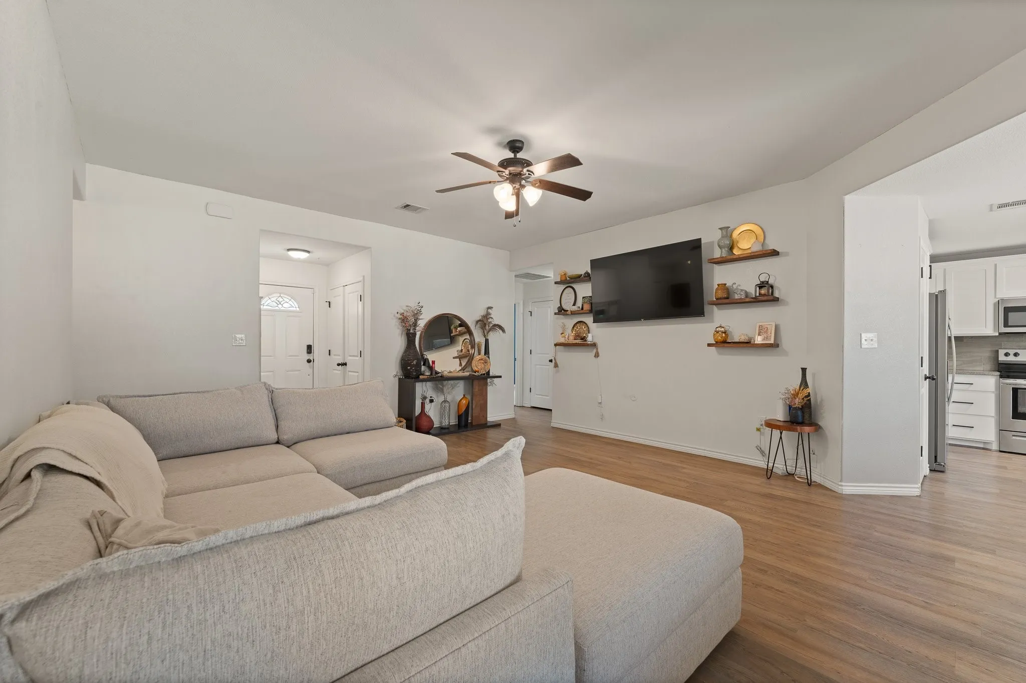 Wood-finish flooring, recessed lighting, and a ceiling fan