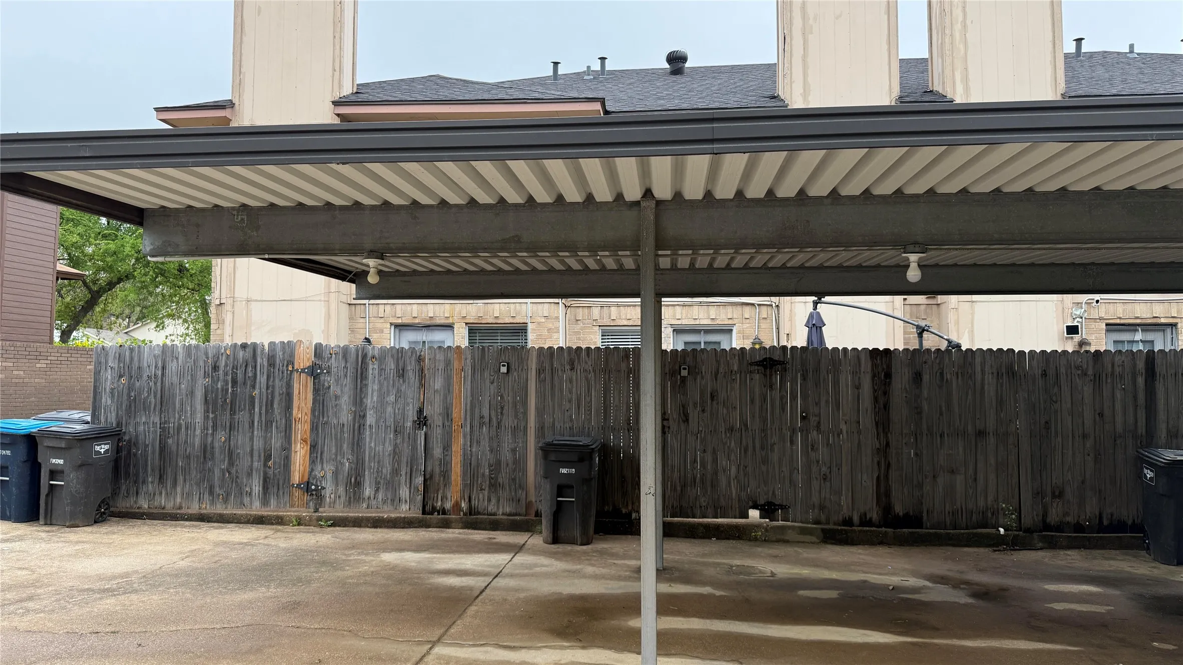 Covered parking lot featuring fence