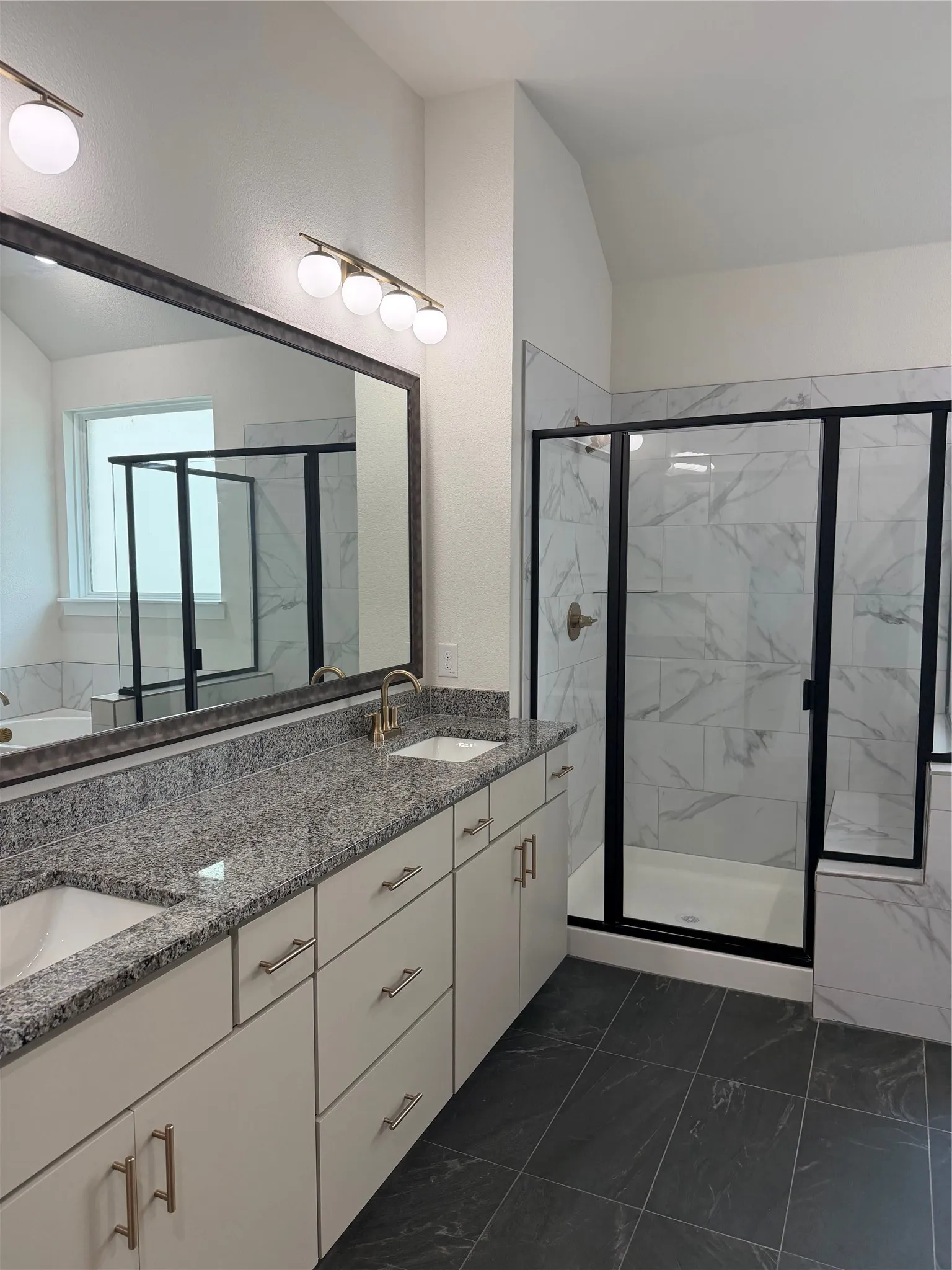 Dual vanity with granite countertops, undermount sinks, and brushed gold fixtures