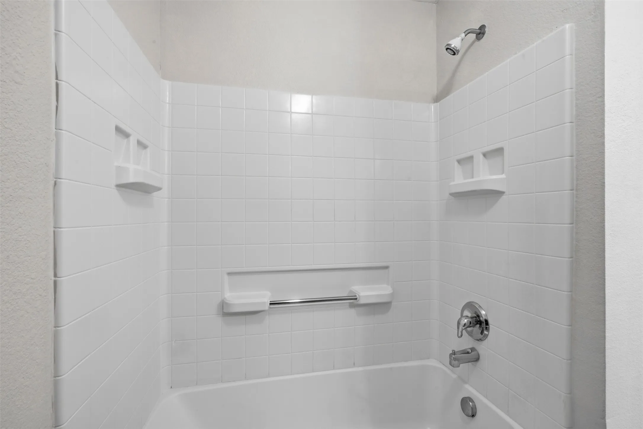Great Tub and Shower with Lots of Space for Your Soaps and Shampoos!