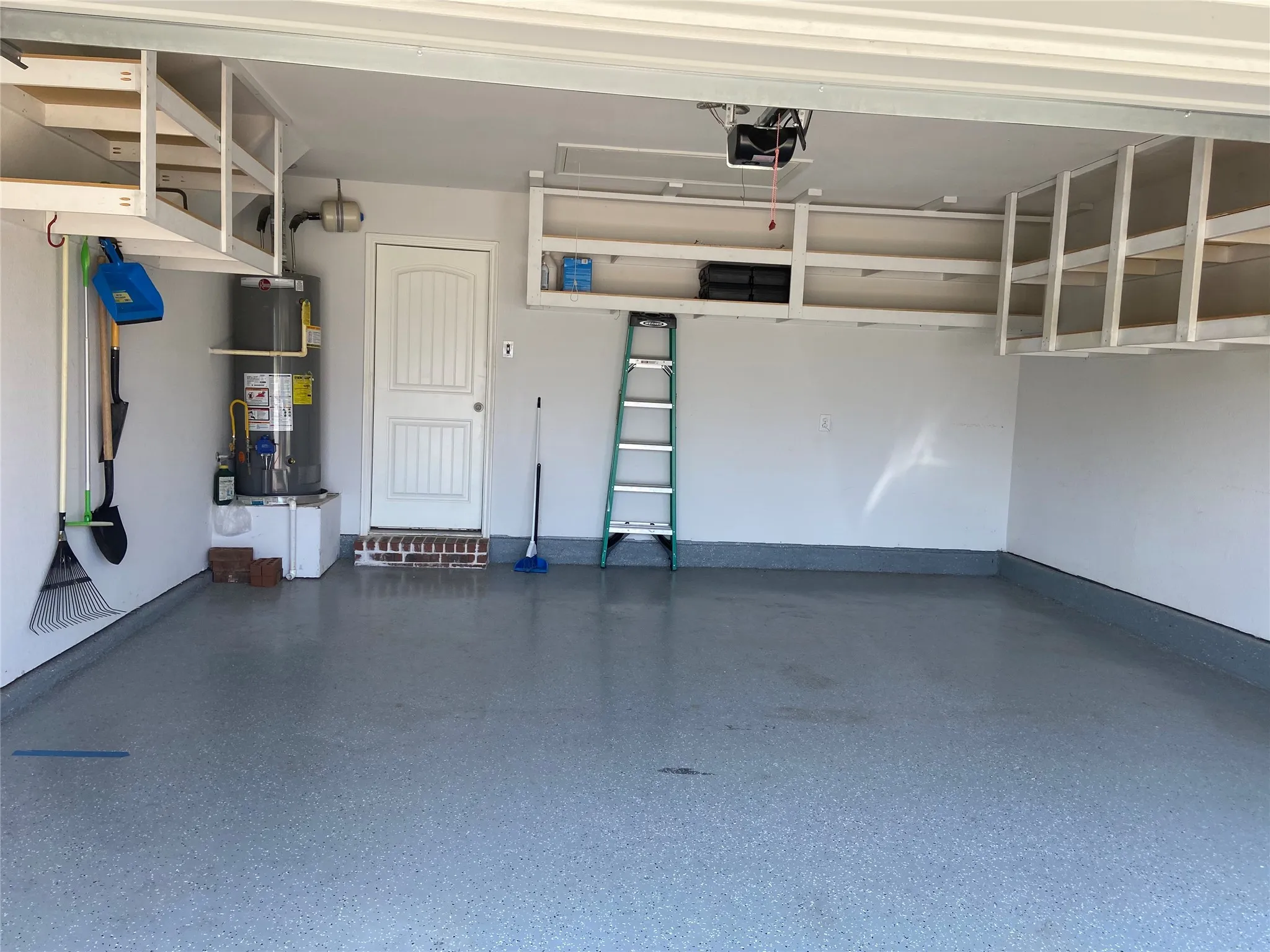 Garage with water heater and a garage door opener