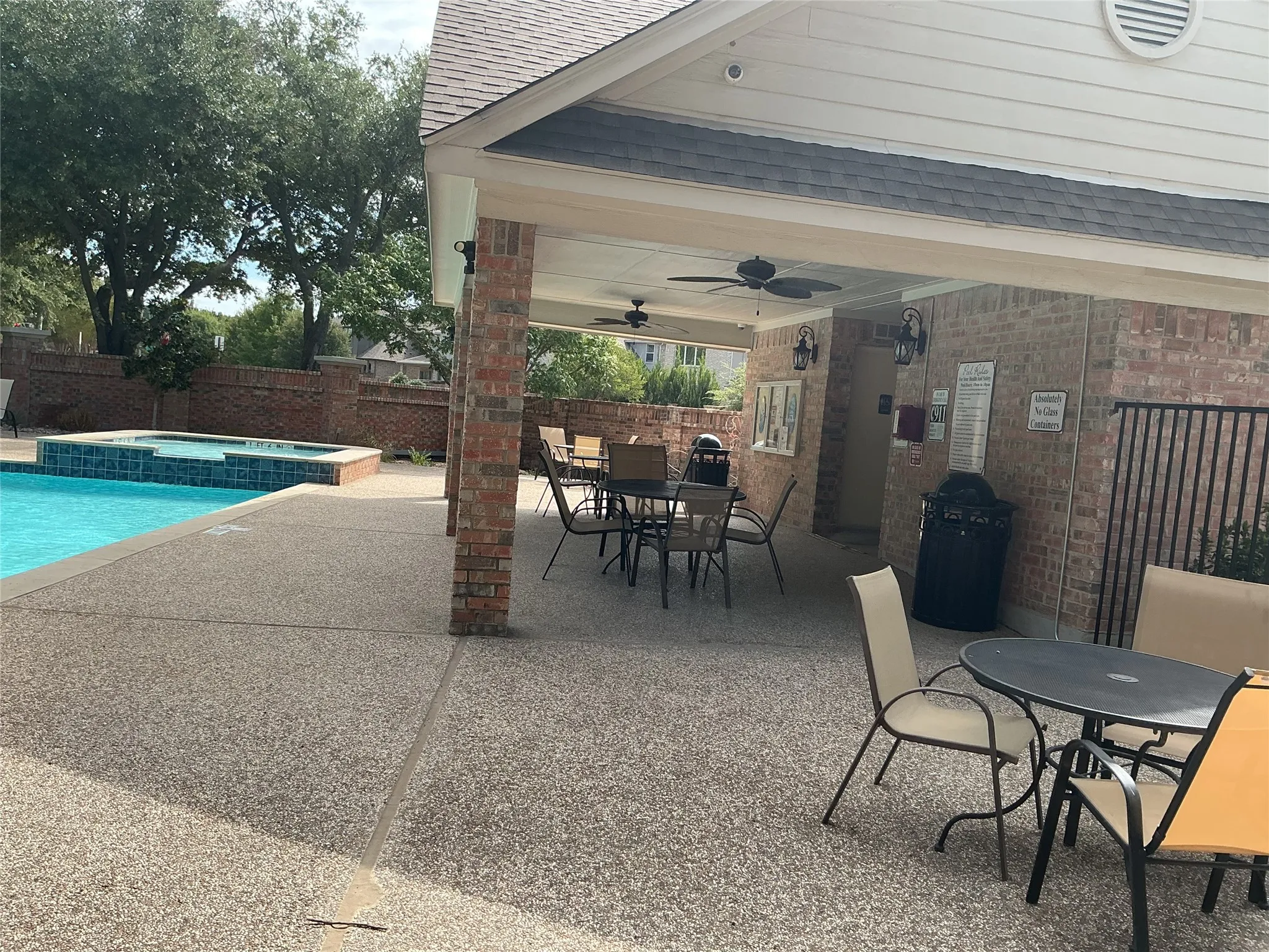 community pool with little pool for kids also, seating area and restroom.