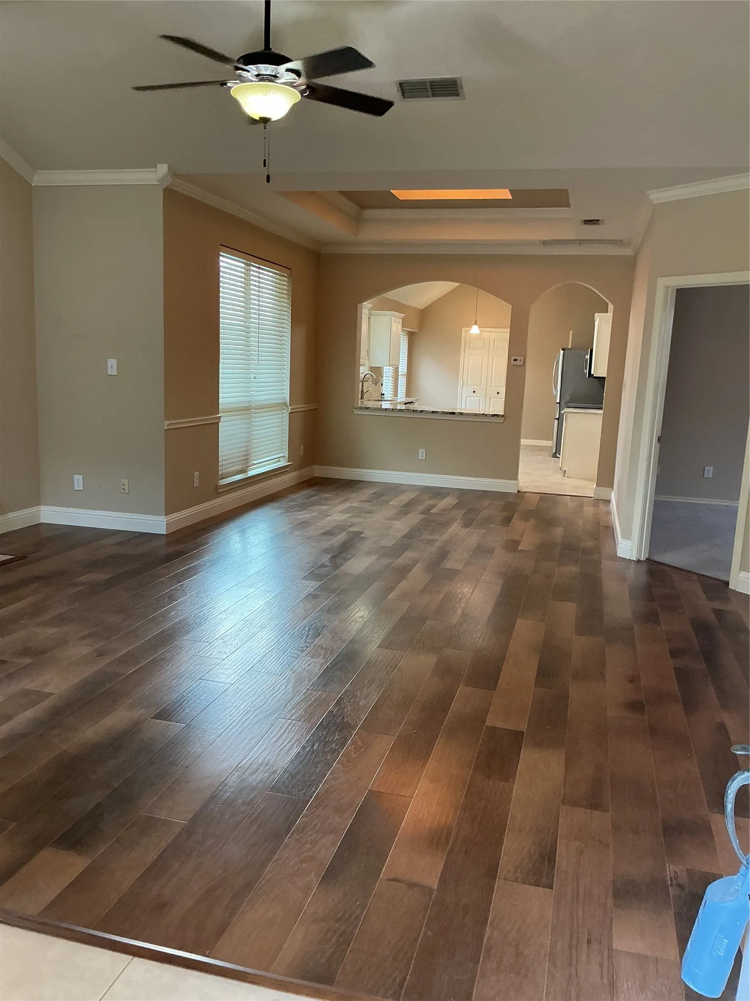 openand bright living a d dining room with wood flooring