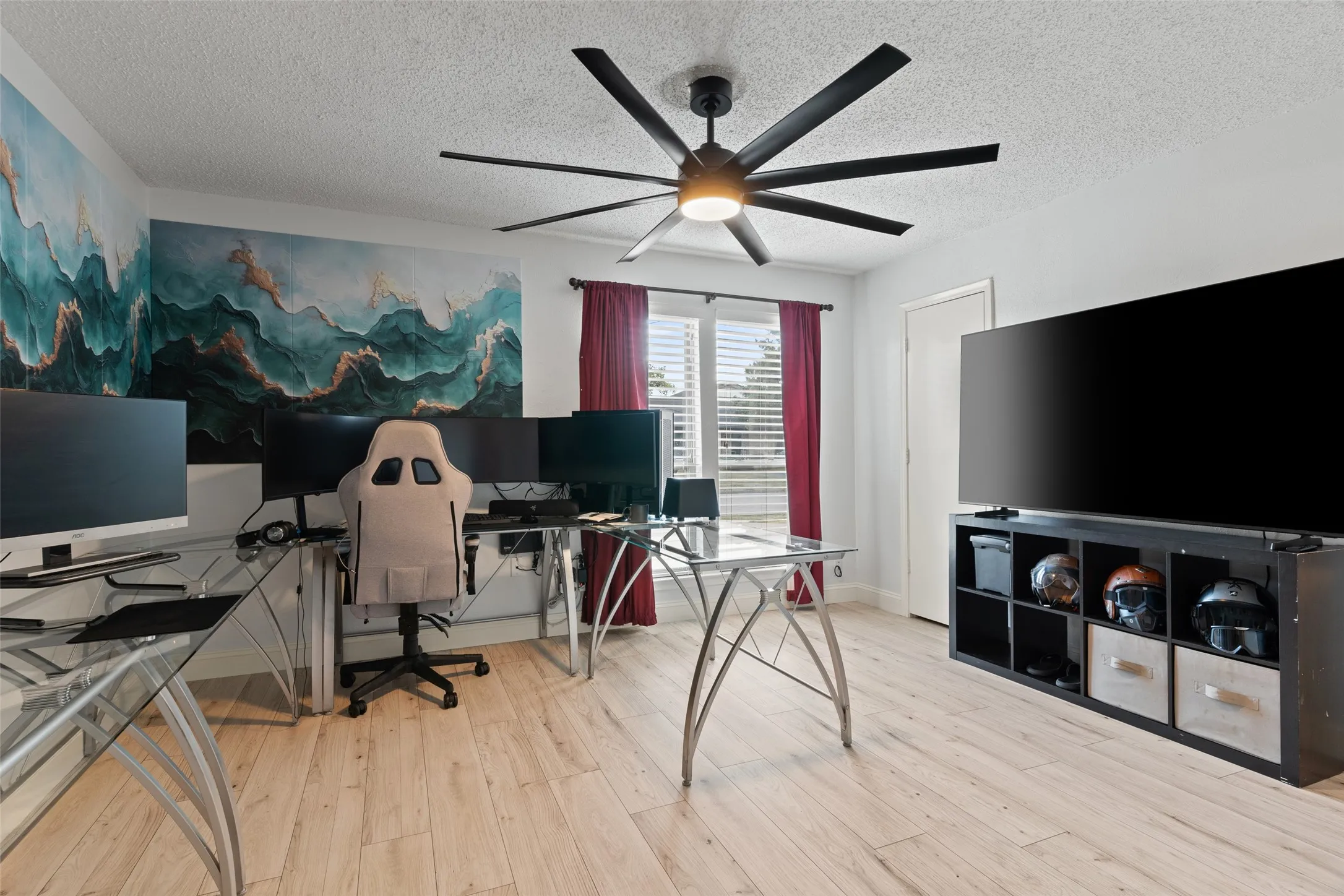 Wood-finish flooring, ceiling fan, and built-in shelving unit