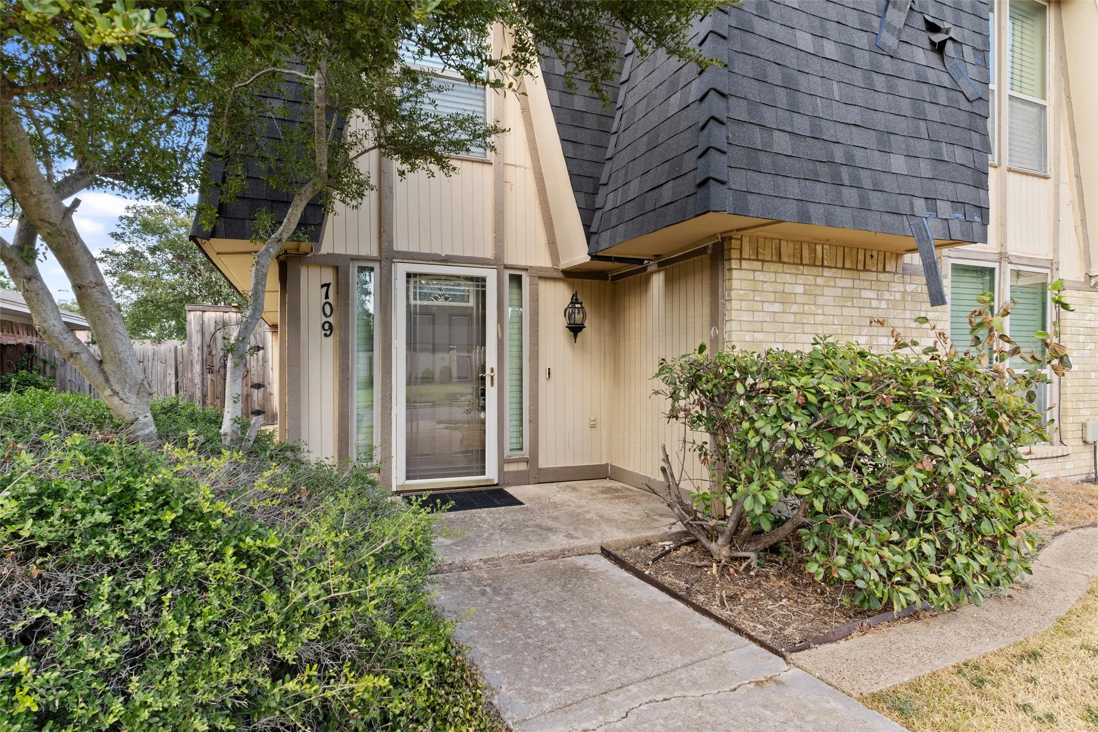 Brick and vertical siding exterior with an angled roofline