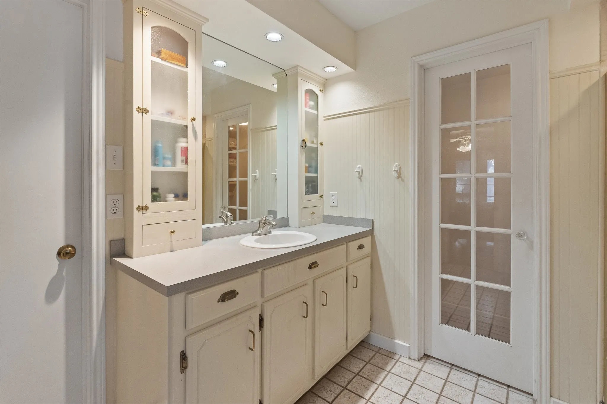 Vanity with an integrated sink, polished chrome faucet, and ample storage cabinetry