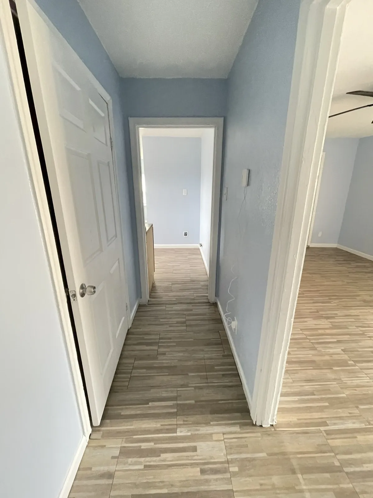 Hall featuring baseboards and light wood finished floors