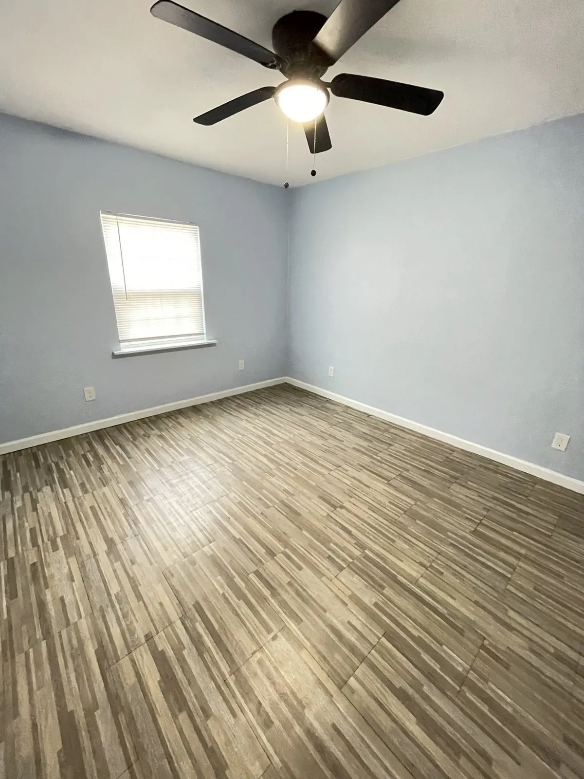 Spare room featuring a ceiling fan and wood finished floors