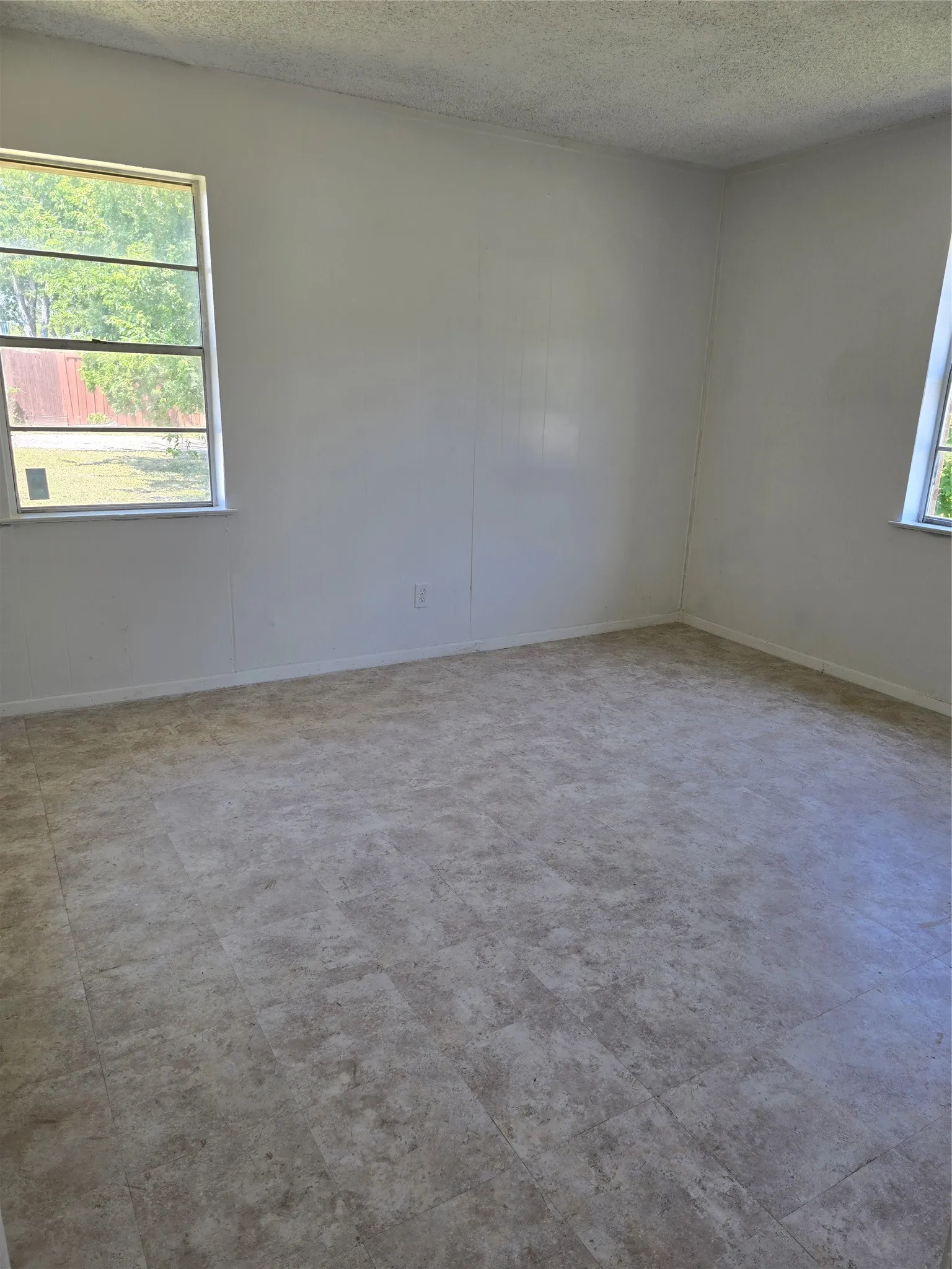 Neutral tone wall finish and textured ceiling