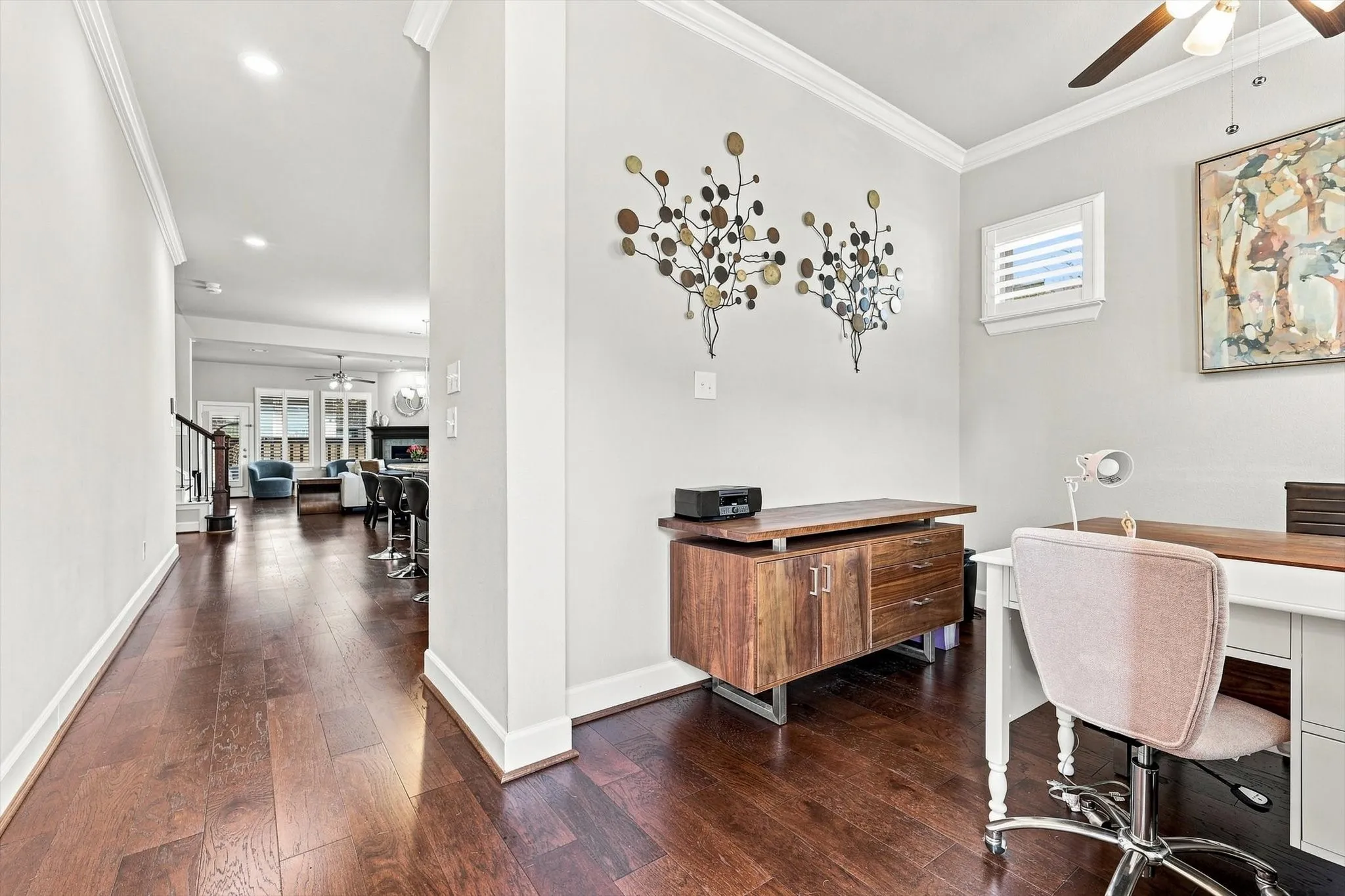 Hardwood-style flooring extends throughout, complemented by crown molding and recessed lighting