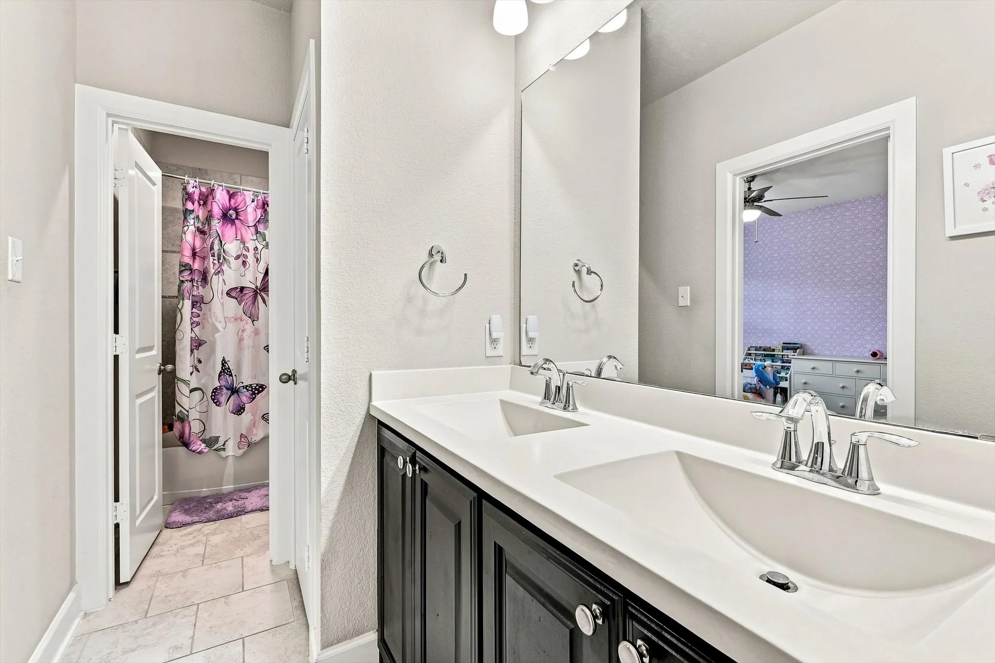 Dual vanity with undermount sinks, chrome faucets, and dark​​‌​​​​‌​​‌‌​‌‌​​​‌‌​‌​‌​‌​​​‌​​ cabinetry