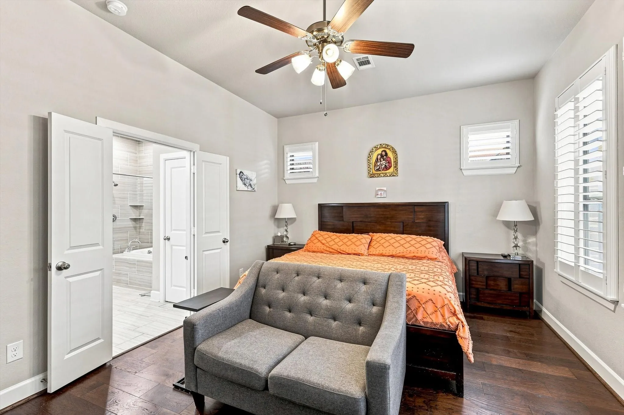 Recessed ceiling lighting, wood-finish flooring, plantation shutters, and a wood ceiling fan