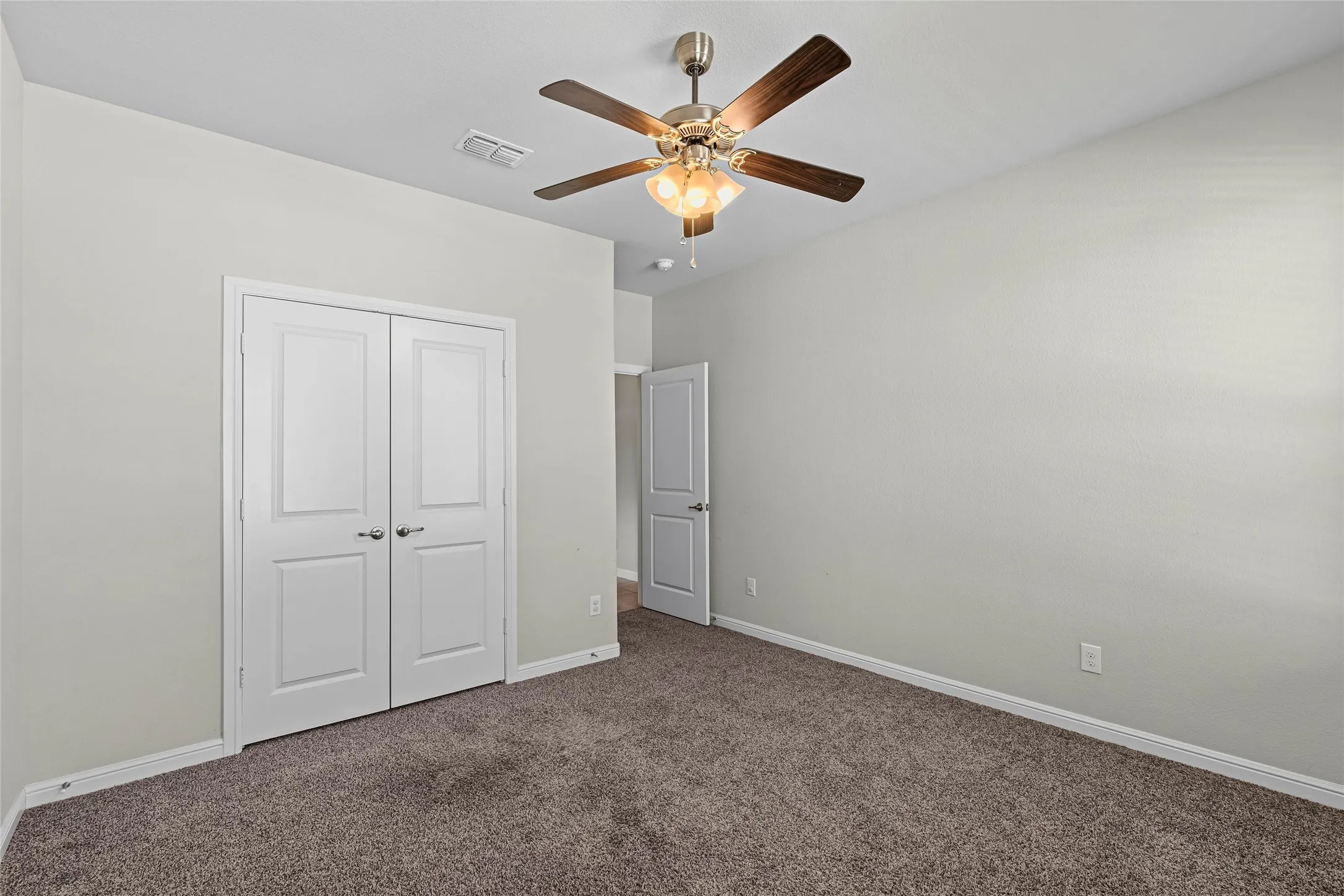Neutral-toned walls complement the carpeted flooring