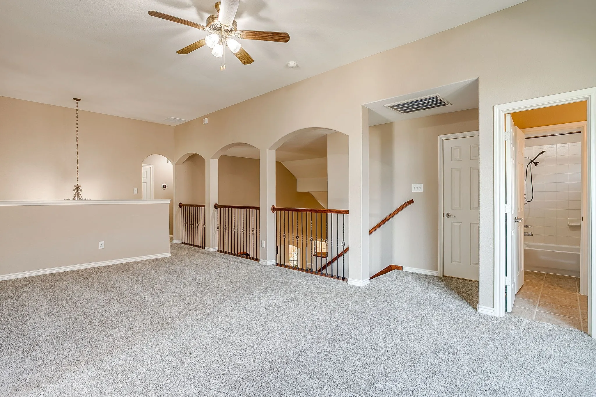 Carpeted upper level with ceiling fan and recessed lighting
