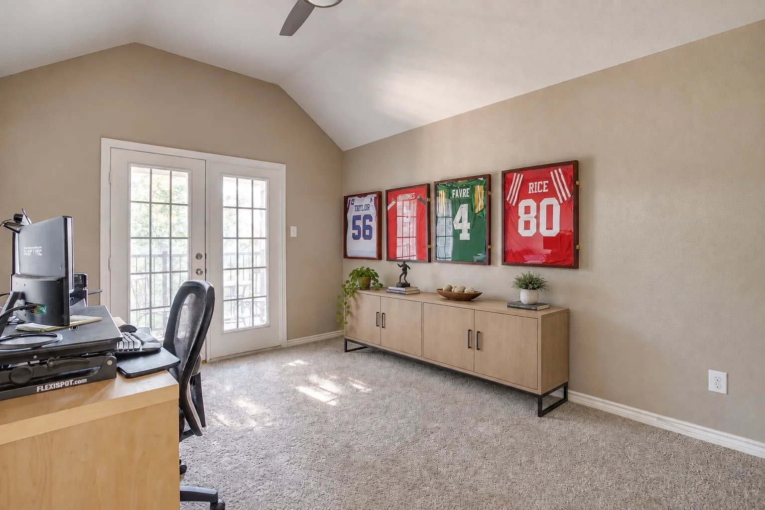 Vaulted ceiling, ceiling fan, French doors which lead to balcony.