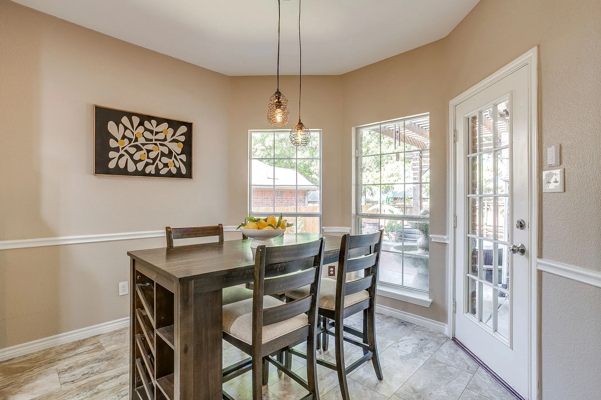 Bay window with multiple panes, glass-paneled door, and pendant lighting fixtures