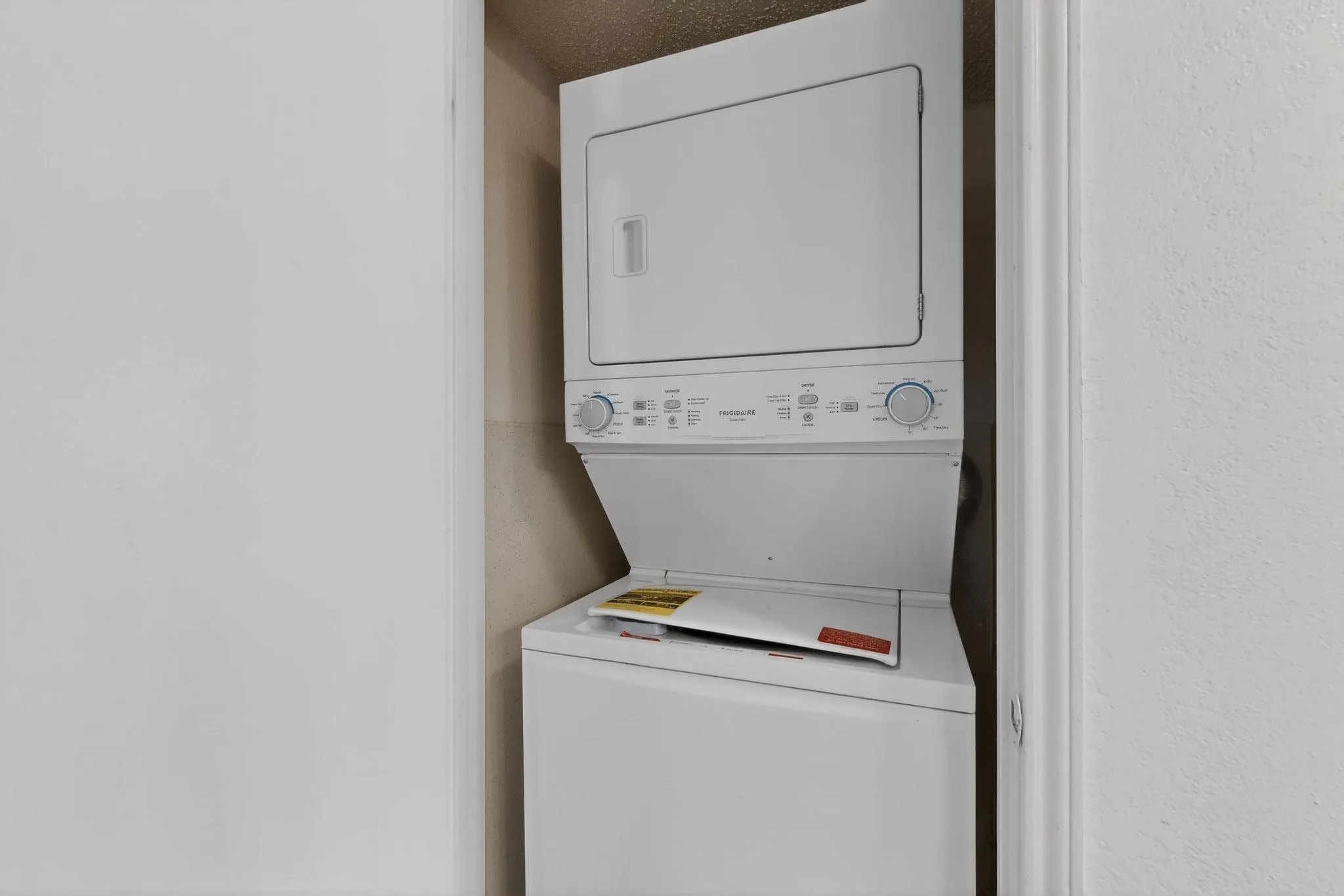 Laundry room featuring stacked washer / dryer