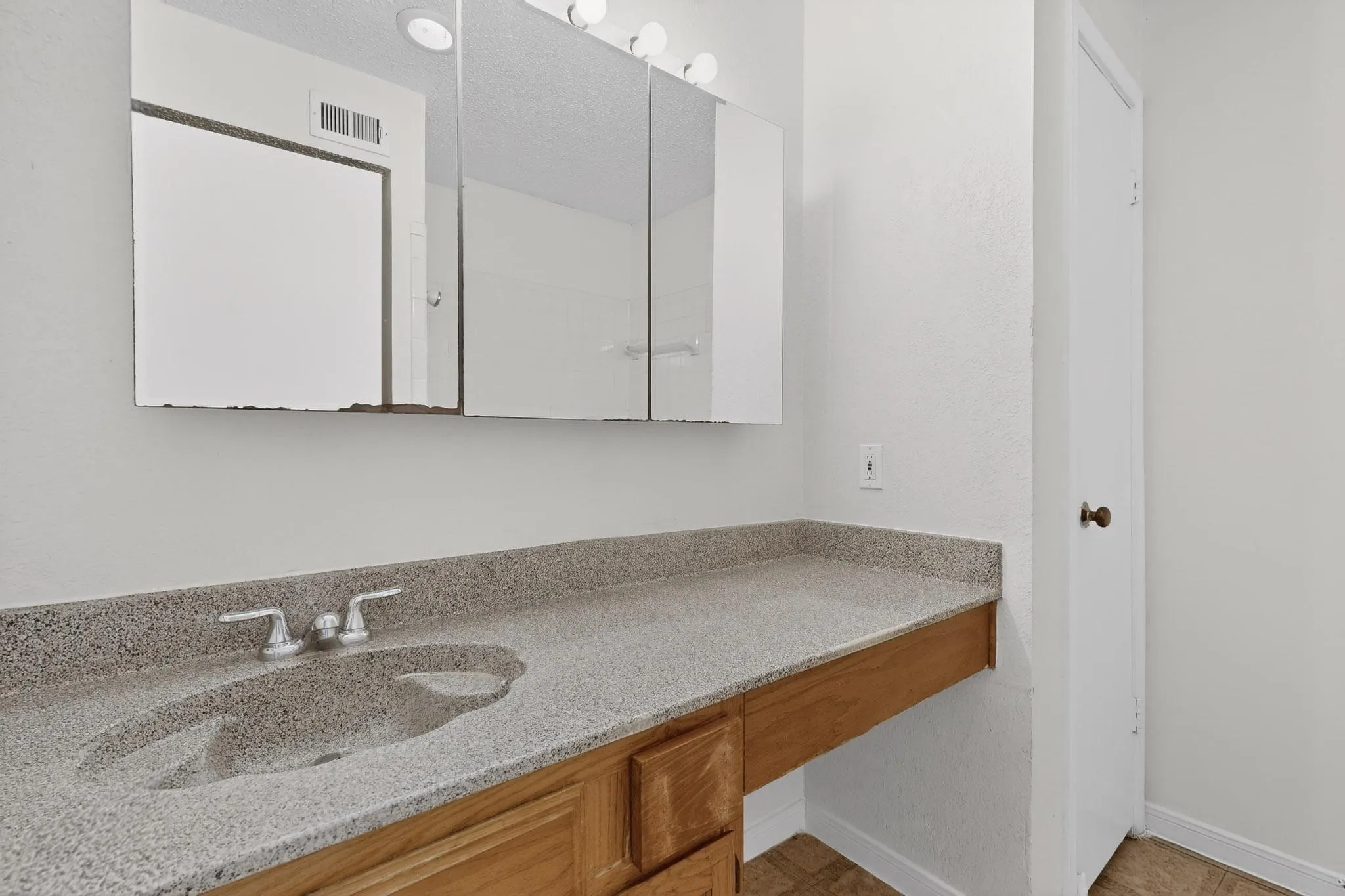 Bathroom featuring vanity and baseboards