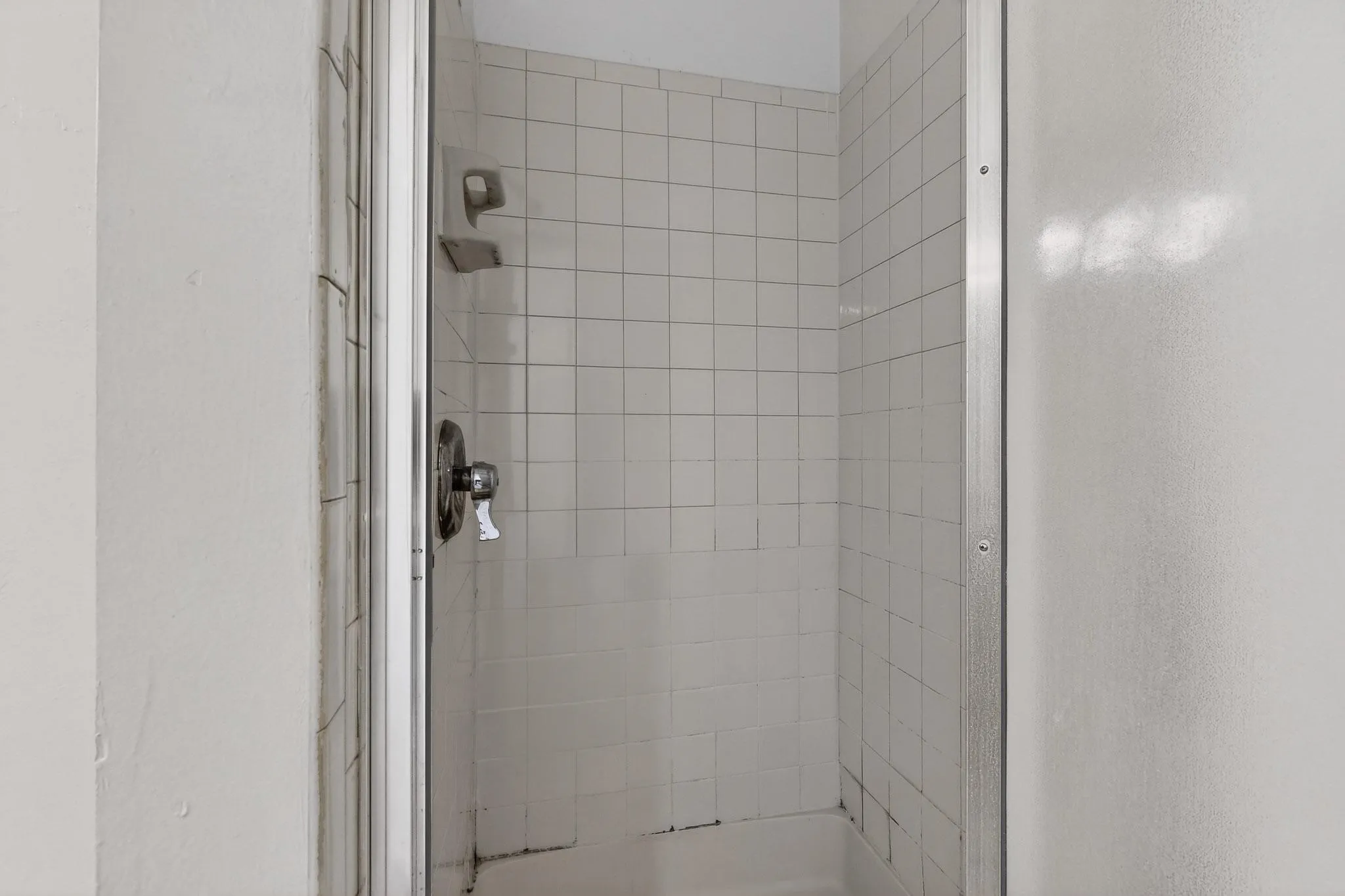 Full bathroom with a shower stall