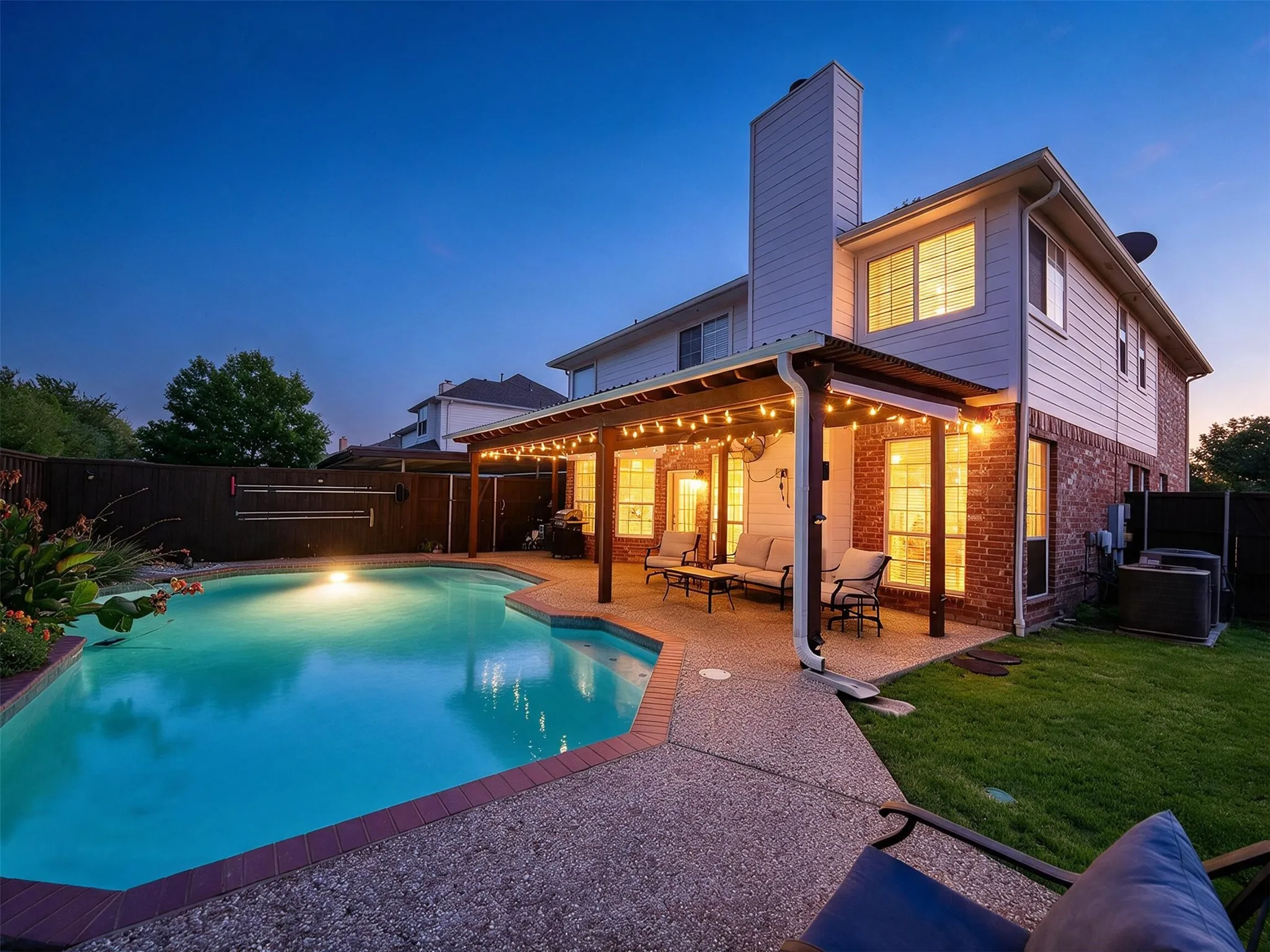 In-ground swimming pool with a surrounding aggregate concrete​​‌​​​​‌​​‌‌​‌‌​​​‌‌​‌​‌​‌​​​‌​​ patio