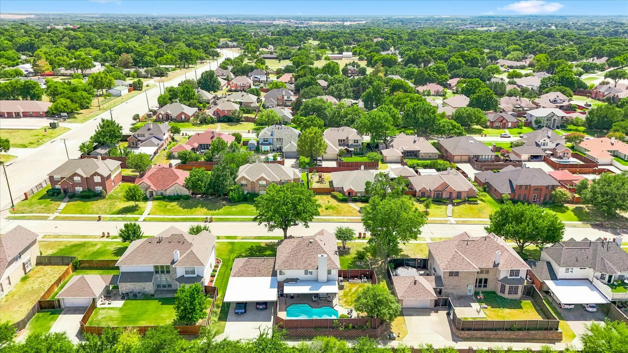Residential neighborhood with mature trees, established streets, and varied architectural styles
