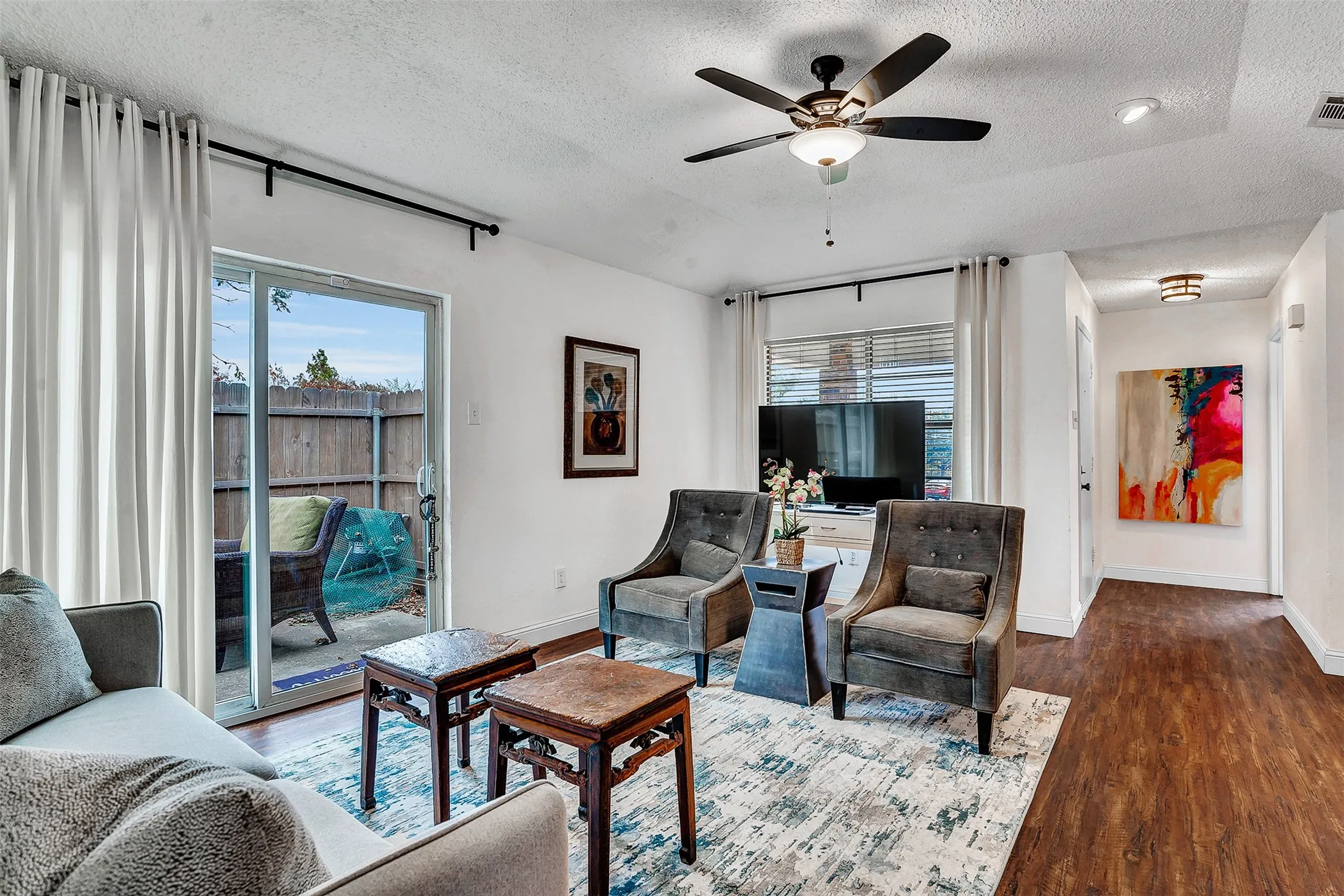 Wood-finish flooring, recessed lighting, and a ceiling fan with integrated lighting