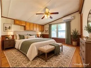 Hardwood-style flooring, paneled walls, ceiling fan, transom windows, and built-in cabinetry