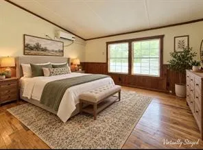 Wood-finish flooring, accent wall paneling, and a mini-split system