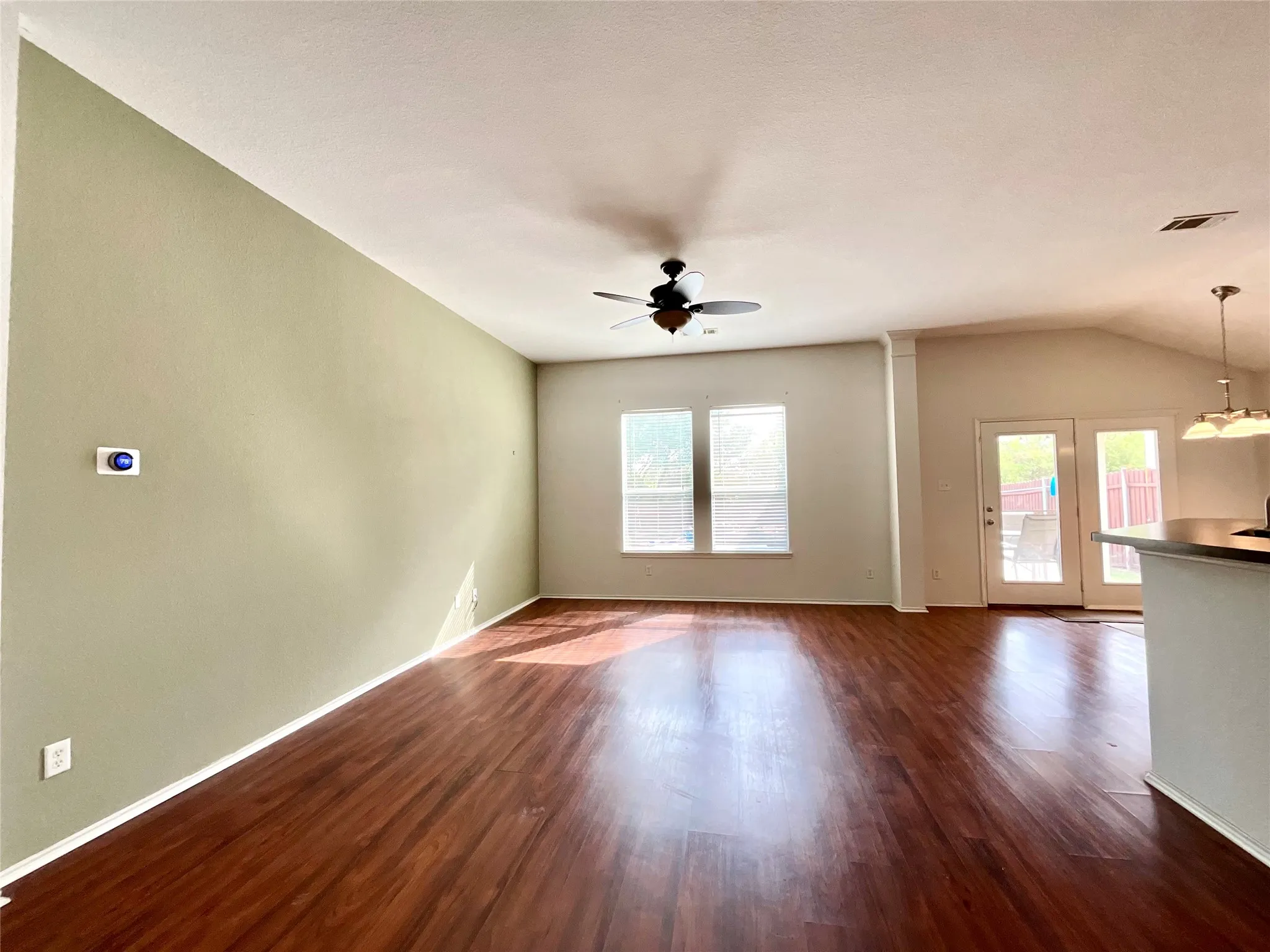 Wood-finish flooring throughout, ceiling fan, and double-pane windows