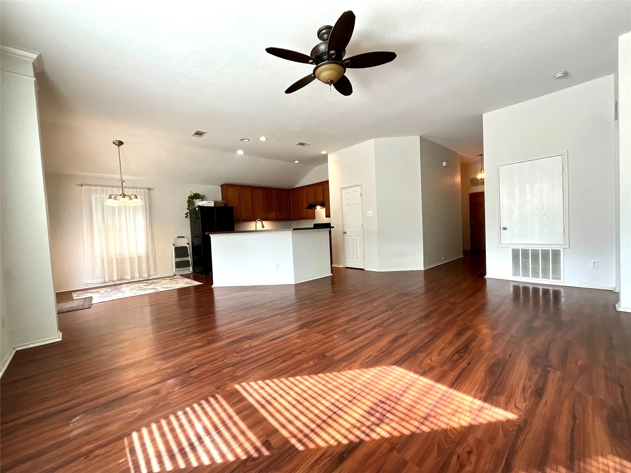 Wood-finish flooring throughout, recessed lighting, and a ceiling fan