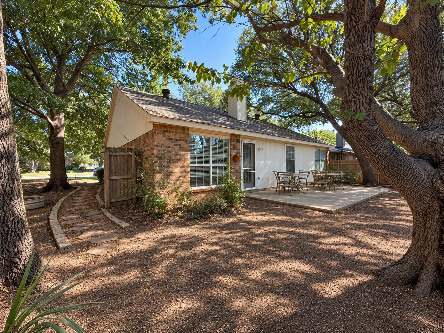 Spacious Outdoor Area with Large Patio & Charming Stone Pathways Offering Plenty of Potential. Back Yard is Currently Not Landscaped/No Grass.