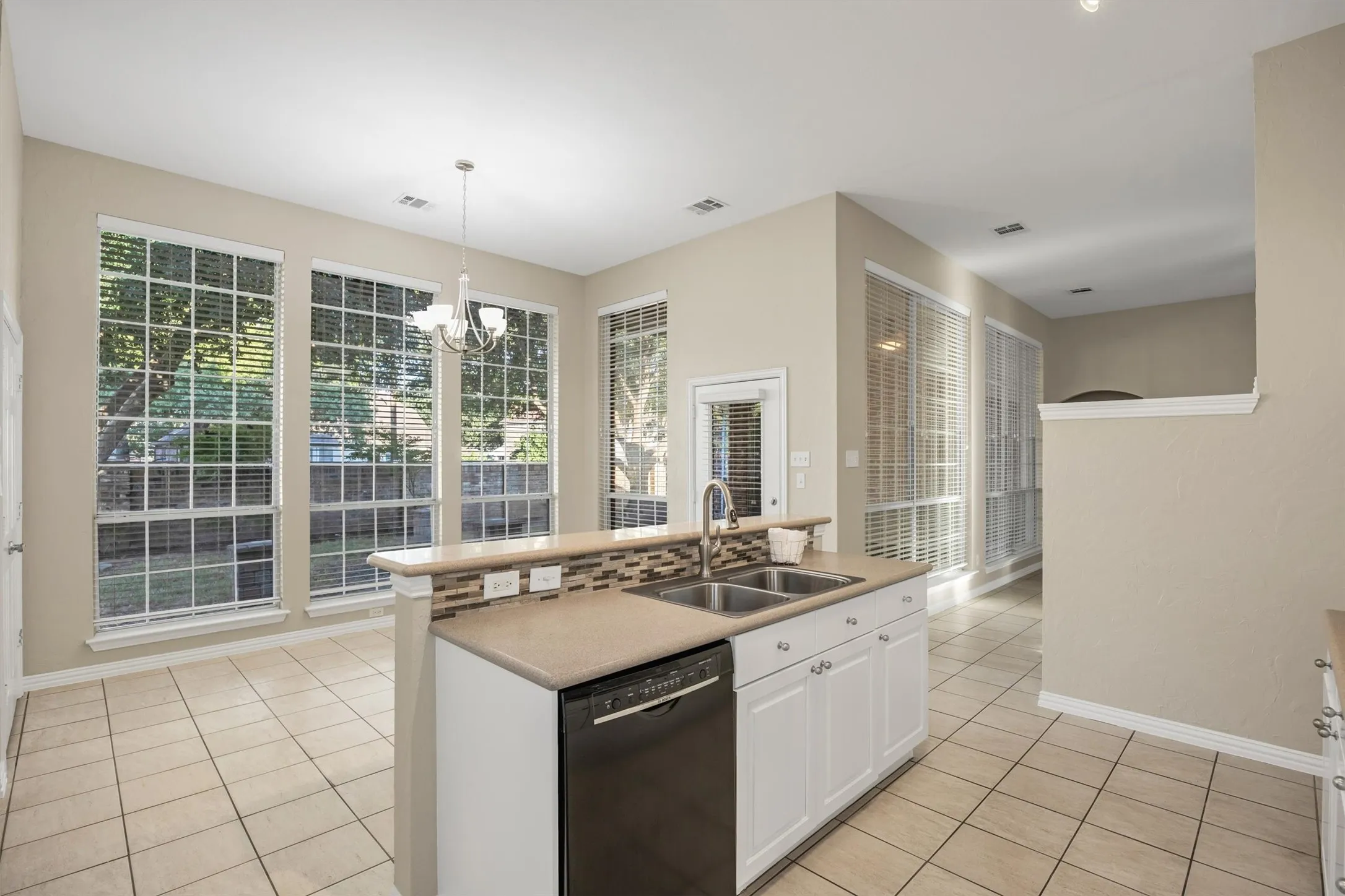 Kitchen island has dishwasher, double sink with disposal and Corian® solid counter tops.