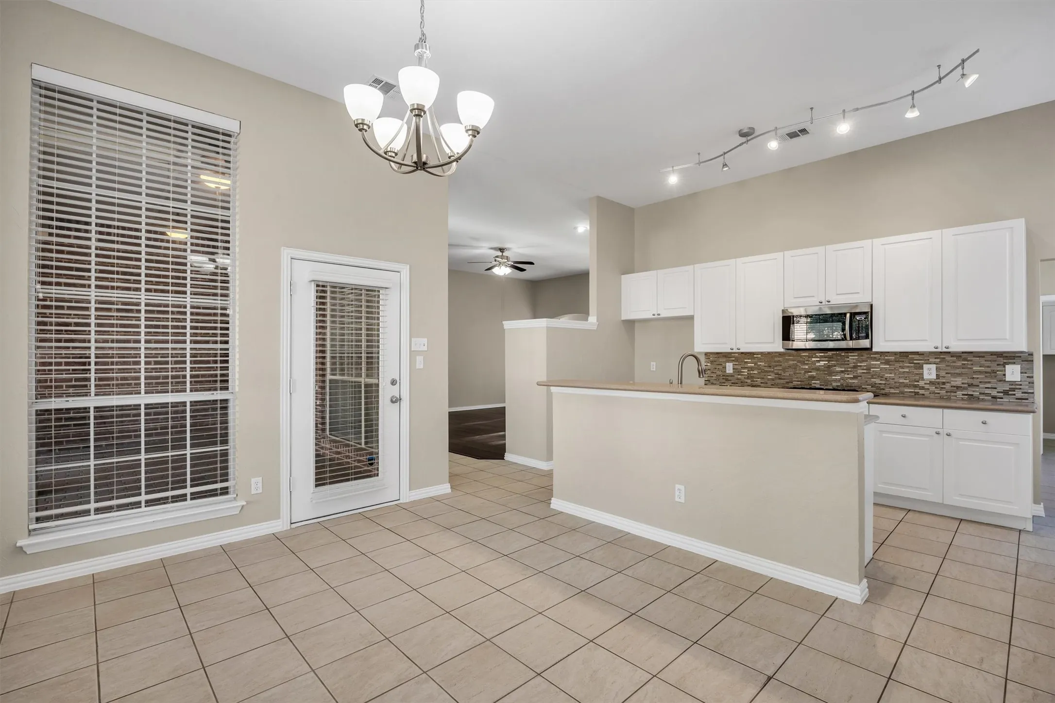 Kitchen opens to covered patio, living room, and dining room.