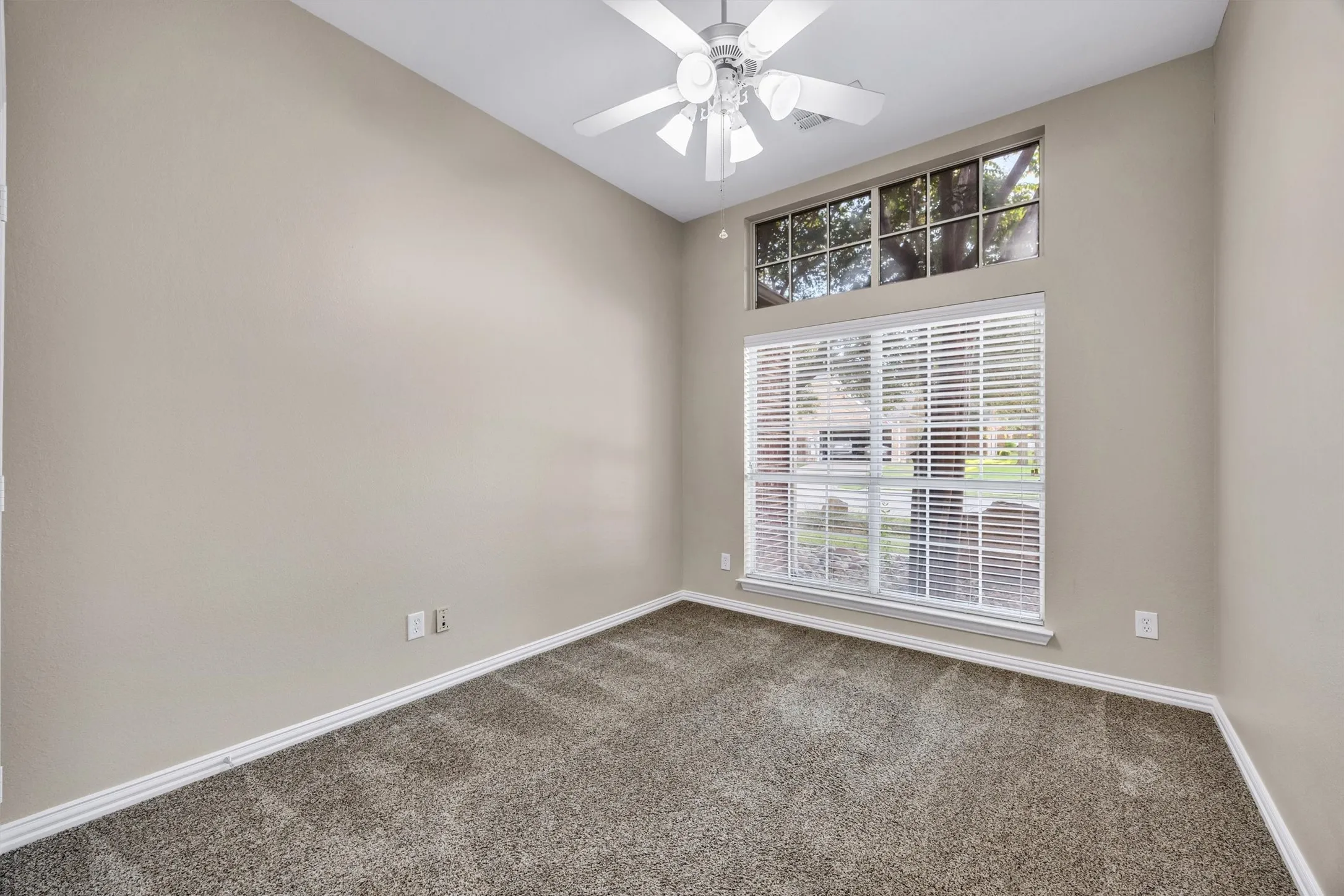 Bedroom 4 is a flex space. makes a great office or study area. It has Vaulted ceiling, a ceiling fan, carpet flooring,  walk in closet, and a large windows