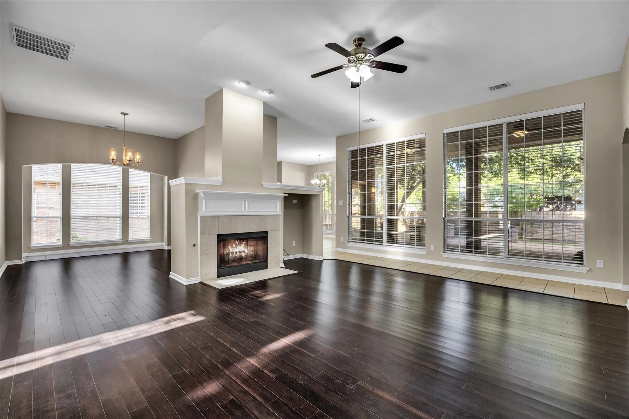 Open-concept area to formal dining room and centered around the fireplace