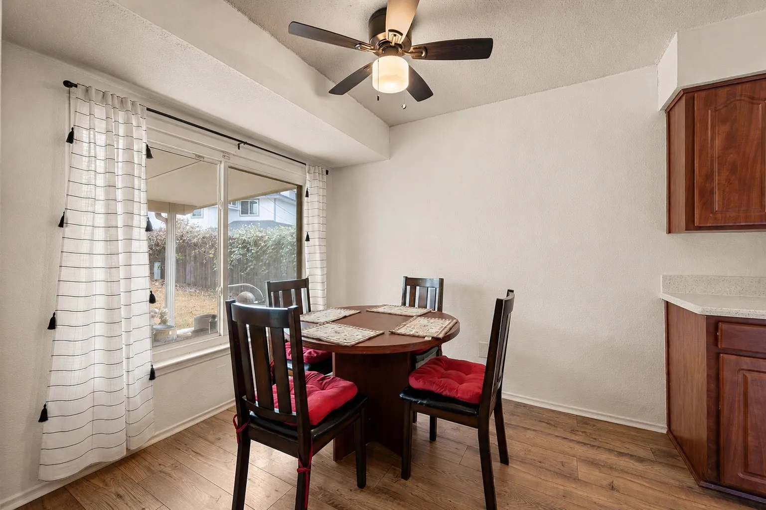 Wood-finish flooring with a ceiling fan light fixture