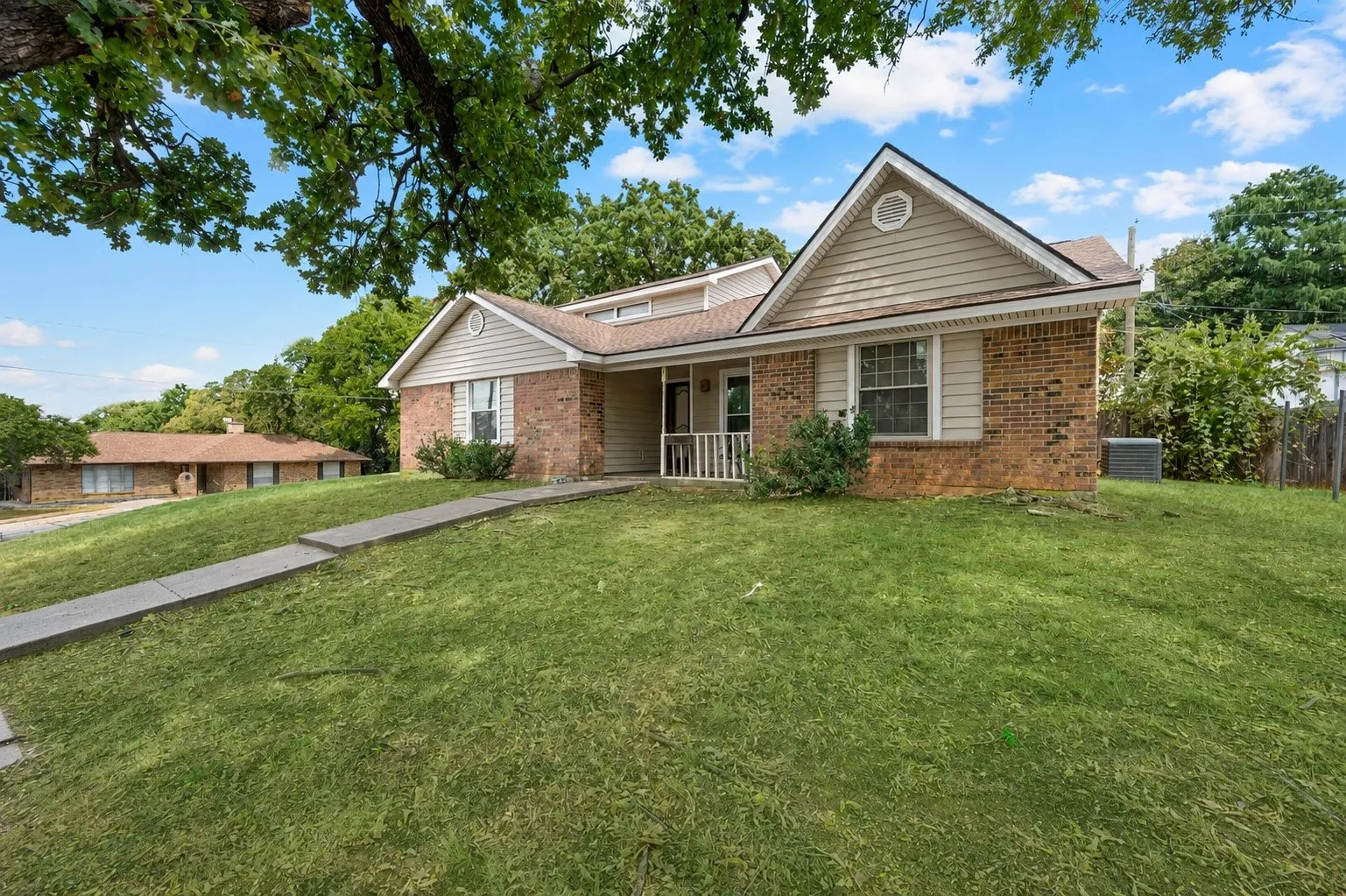 Brick exterior with siding accents and a gable roof