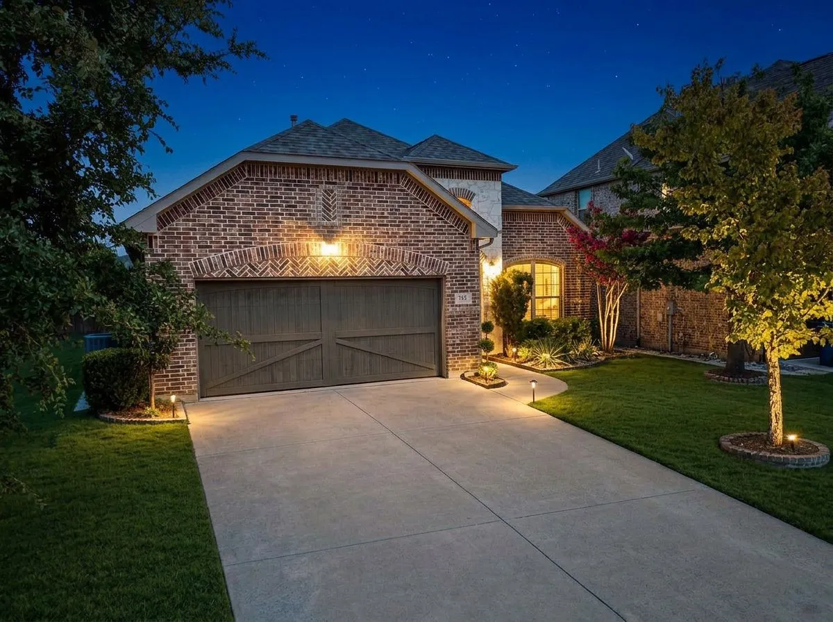 Brick and stucco exterior with an arched garage door