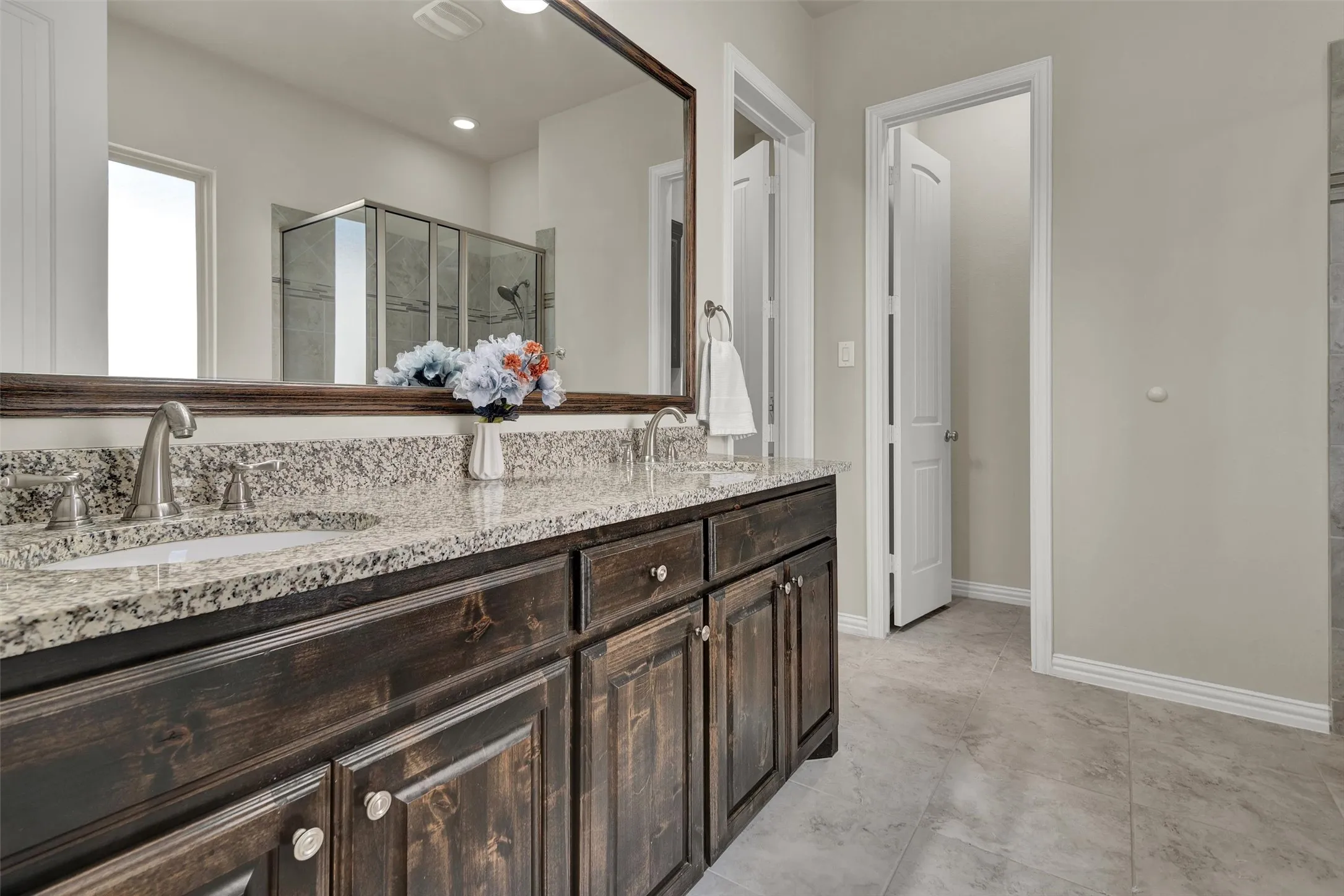 Dual vanity with granite countertops, undermount sinks, and brushed nickel fixtures