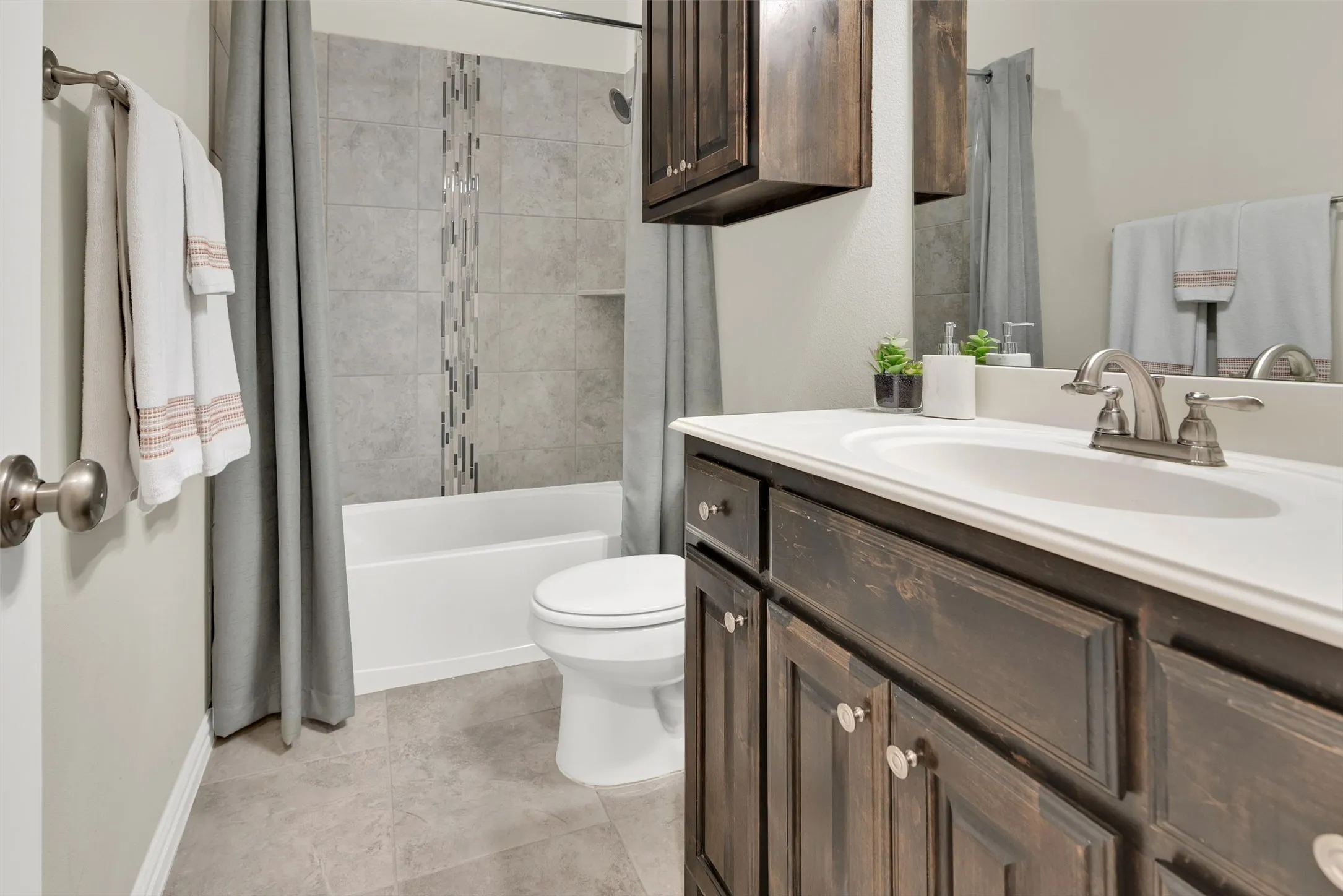 Built-in vanity with a white countertop and undermount sink