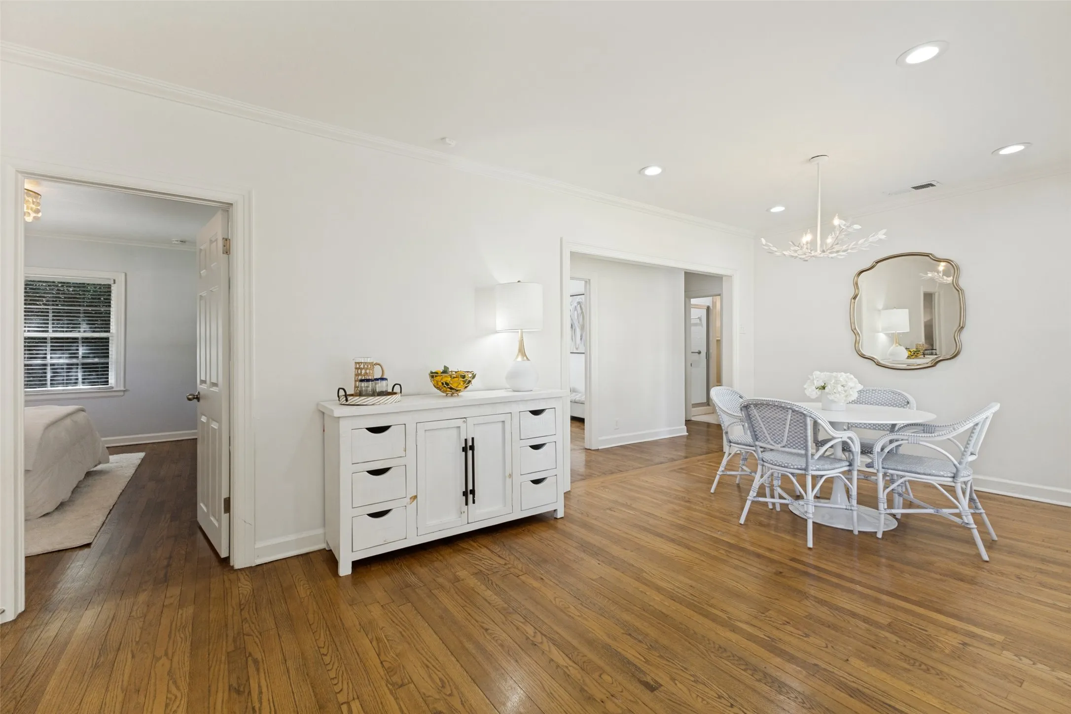 A peek into the primary bedroom on the left and additional bedrooms to the right.