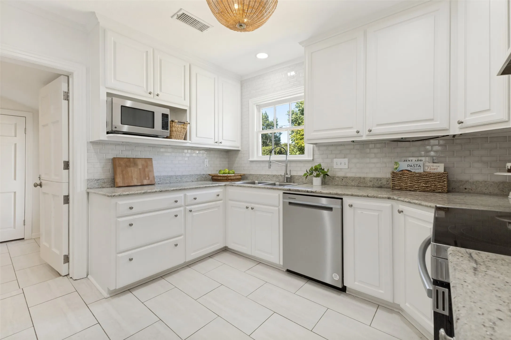 Stainless appliances and a kitchen faucet are recent additions to this well-appointed kitchen with ample storage.
