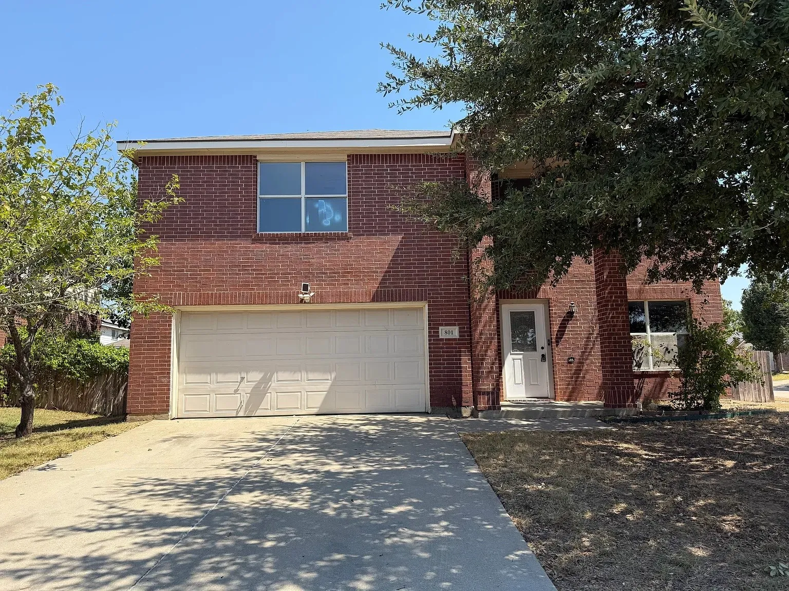 Two-story brick exterior with a front entry and an attached two-car garage